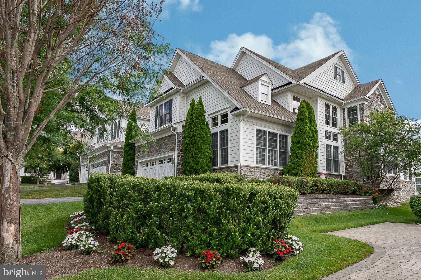 Welcome to 305 Sunny Brook Lane, a move-in ready, end unit Carriage Home located in the desirable “Village” section of Liseter. Enjoy convenient access to the community amenities, post office, and Pavilion Park, all just a short distance away.  Ideally situated with a desirable southern exposure, this home is filled with abundant natural light, enhanced by “Savannah Shadings” that softly filter sunlight while maintaining bright, inviting living spaces. Dramatic vaulted ceilings in the Great Room, Office, and Sunroom create an open, airy feel, beautifully complemented by nine-foot ceilings in the Kitchen and Dining area, and an elegant tray ceiling in the Primary Bedroom.
A sophisticated two-story Foyer with hardwood flooring welcomes you inside, where classic wainscoting, tall baseboards, and extensive millwork create a timeless first impression. French doors open to a vaulted private Home Office, providing a quiet workspace just off the Foyer.
The open floor plan is anchored by the expanded Great Room, featuring a vaulted white beamed ceiling, architectural molding, a gas fireplace, and French doors leading to the Sunroom. Surrounded by windows and enhanced by the home's southern exposure, the vaulted Sunroom is filled with natural light and provides an inviting extension of the main living space overlooking the rear deck.
The gourmet Kitchen is designed for both everyday living and entertaining, featuring KitchenAid stainless steel appliances, gas cooking, granite countertops, rich cabinetry, a center island with a double sink.  The expanded adjacent Dining Area offers a perfect setting for formal meals or casual breakfasts.
The first-floor Primary Bedroom Suite features a tray ceiling accented with crown molding, a generous walk-in closet, and a private en-suite Bath with a dual-sink granite vanity, tile flooring, a walk-in shower, and a separate water closet. Completing the main level are a Powder Room, Laundry Room, and direct access to the attached two-car Garage.
A curved staircase leads to the second level, where a Loft with hardwood flooring and double crown molding provides flexible living space. Two additional Bedrooms with carpeting, generous closet space, a full Hall Bath, and a walk-in storage room complete the upper level.
The finished Lower Level offers exceptional additional living space, including a Recreation Area, dedicated Fitness Area—with all gym equipment included—and abundant unfinished storage. The Basement is also pre-plumbed for a future Full Bath.
Significant recent improvements include a new HVAC system (2024) with a transferable 10-year warranty, new hot water heater (2024), updated plumbing (2024), and a new washer and dryer (2026).
Outdoor living includes a spacious rear deck with comfortable seating, lush green lawns and professionally landscaped grounds offering a quiet, peaceful setting.
Residents of Liseter enjoy access to community amenities including a clubhouse, fitness center, swimming pool, tennis courts, pickleball courts, basketball court, bocce courts, walking trails, parks, and open green space.  Conveniently located near shopping, dining, major roadways, and the centers of Newtown Square and Wayne, this home offers the perfect value combination of thoughtful updates, quality finishes, a great location, and move-in ready.