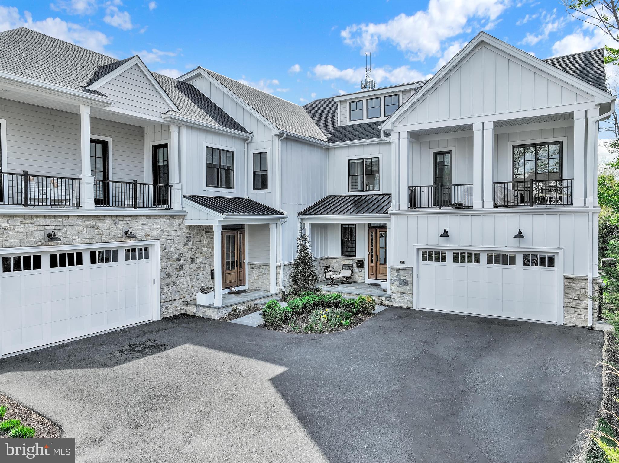 Set along one of the most coveted stretches of Main Street in New Hope, this exceptional Riverwalk residence represents a refined expression of luxury living, where sophisticated design, elevated finishes, and an extraordinary walkable setting converge seamlessly. Built just four years ago by Barley Custom Homes, the home showcases impeccable craftsmanship and thoughtfully curated interiors across nearly 3,600 square feet.
A welcoming front porch offers a graceful introduction before opening into a light-filled interior defined by soaring 10-foot ceilings and a dramatic foyer. Designed with both elegance and livability in mind, the main level unfolds effortlessly, anchored by a stunning great room with fireplace and walls of tall glass doors that flood the space with natural light while creating a seamless connection between indoors and out. The great room flows seamlessly into the chef’s kitchen, complete with Wolf  Sub-Zero appliances, a six burner range, a generous walk-in pantry, and spaces tailored for elevated entertaining and everyday ease. A private office, thoughtfully designed mudroom with abundant storage, and attached two-car garage further enhance the home’s functionality without compromising design.
Perfectly positioned along the towpath with the Delaware River just across the street, the setting offers a rare balance of privacy and connection. Enjoy effortless walkability to the acclaimed restaurants, boutiques, galleries, and vibrant cultural energy that define New Hope, while the charming river town of Lambertville is just moments away. Here, daily life is immersed in the beauty and rhythm of one of the region’s most sought-after destinations.
The second level features four beautifully appointed bedrooms, each complemented by their own ensuite bath, offering both comfort and privacy throughout. One bedroom opens directly to a private balcony, creating a quiet retreat overlooking the surrounding landscape. The primary suite is a sophisticated sanctuary, featuring a spa-inspired bath with an oversized glass shower, dual vanities, and a sleek, modern aesthetic designed with understated luxury in mind. A well-positioned second-floor laundry room and airy loft space further elevate the home’s thoughtful design and livability.
An elevator services all floors, leading to a third-floor loft and flex space complete with a full bath, ideal for a guest retreat, lounge, playroom, or additional living area, along with generous storage integrated throughout.
Outdoor living is equally compelling, with a private deck overlooking the towpath and a setting that effortlessly blends nature, luxury, and walkable Main Street living.
This is more than a home, it is a rare lifestyle offering in one of Bucks County’s most iconic river towns, where timeless architecture, effortless luxury, and an unparalleled location come together in a way that must be experienced to be fully appreciated.