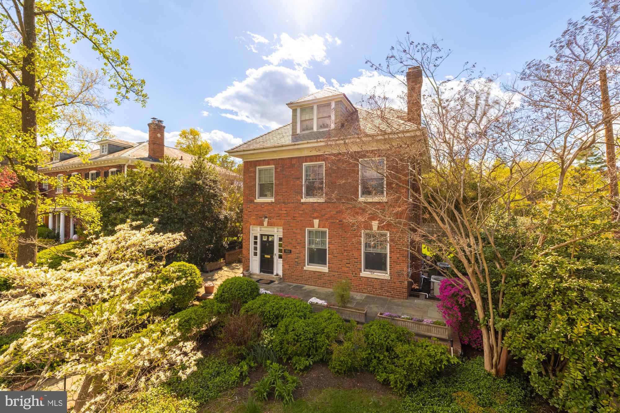 A stately and beautifully reimagined colonial in Woodley Park, this completely renovated residence offers timeless elegance and modern comfort across four expansive levels. Once owned by Michael Collins, the Apollo 11 astronaut who was the command module pilot on the first lunar mission to the moon, this home carries a rare legacy along with its remarkable design. With five bedrooms, four and a half bathrooms, and rare two-car garage parking, it delivers exceptional space, thoughtful design, and high-end finishes throughout. Inside, stunning hardwood floors run throughout sun-drenched living spaces. 

The welcoming foyer opens to a gracious formal living room with a fireplace and detailed crown molding, leading to an expansive dining room and an incredible light-filled sunroom. French doors open to a beautifully landscaped backyard and flagstone patio—an oasis tucked away from the city. The well-equipped kitchen is outfitted with premium Wolf and Sub-Zero appliances and an adjacent casual dining area. The main level also features a powder room. 

Upstairs, find two bright bedrooms including a secondary suite with an ensuite bath plus a sunny front facing office. The primary suite is a true retreat, boasting a walk-in closet, sunroom with a wood-burning fireplace, and a large ensuite bath. The top level offers two more bedrooms with charming details, like a cozy window seat, plus another full bath. The fully renovated lower level includes a large wine cellar, wet bar with wine storage, and a versatile den, ideal as a fitness space. A bedroom with an ensuite bath completes the basement. 

The home has undergone extensive improvements, including replacing floors, walls, and ceilings, adding central heating, completing the rear addition, enhancing the landscaping with new fencing and holly plantings, and more—resulting in a polished and private haven in one of DC’s most desirable neighborhoods.  Located in the sought-after Woodley Park neighborhood, enjoy nearby conveniences like the Washington National Cathedral, Whole Foods, top-rated restaurants, shops, gyms, and schools like Maret, NCS, St. Alban’s, Eaton Elementary and Hardy Middle School. Don’t miss this incredible opportunity, schedule a showing today!