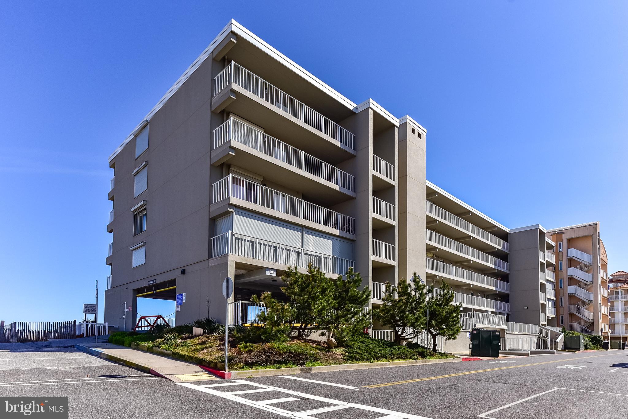 Welcome to this rarely available north-end, direct oceanfront unit in the highly sought-after Pelican Beach — a well-maintained, mid-rise masonry building in North Ocean City near the Delaware line. This spacious 3-bedroom, 2-bath condo offers a unique private entrance leading to the west-facing bayside balcony, perfect for storing bikes, beach gear, and relaxing in your own secluded space. On the other side, soak in panoramic views from the oceanfront balcony that stretches up and down the shoreline. Inside, the open-concept floor plan maximizes natural light and delivers stunning ocean views from nearly every angle. The oceanfront primary suite features private balcony access, generous closet space, and an en suite bath. Two additional bedrooms are thoughtfully situated on the west side for added privacy. Pelican Beach is a low-density building with just 28 units and an expansive beach area, giving you and your guests plenty of space to relax and enjoy the sun. Covered parking for 2 assigned spaces, elevator service, completed reserve study, and excellent professional management provide peace of mind for owners. With dining, shopping, and entertainment all within walking distance, this is your opportunity to own a slice of paradise in one of Ocean City’s most desirable buildings. Don’t miss it!