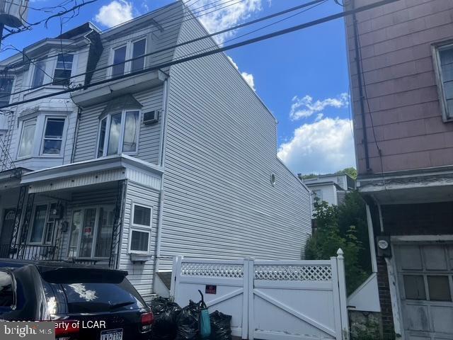 Affordable living with tons of space and an extra lot for off street parking. This end unit townhome features 5 bedrooms,  1 bath, large living room and dining room, cute yard, oil  heat and enclosed off street parking.