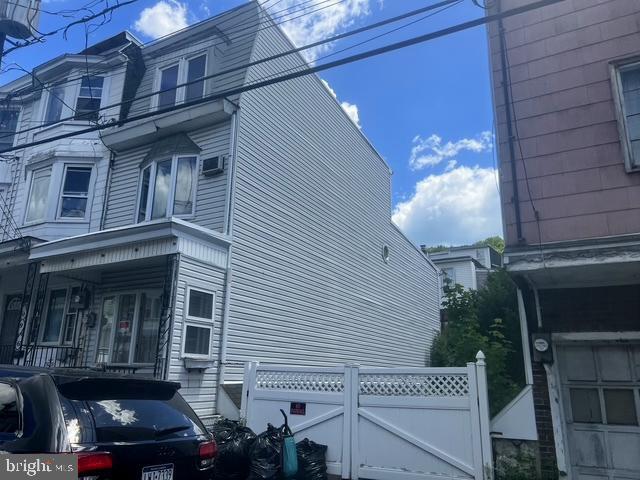 Affordable living with tons of space and an extra lot for off street parking. This end unit townhome features 5 bedrooms,  1 bath, large living room and dining room, cute yard, oil  heat and enclosed off street parking.