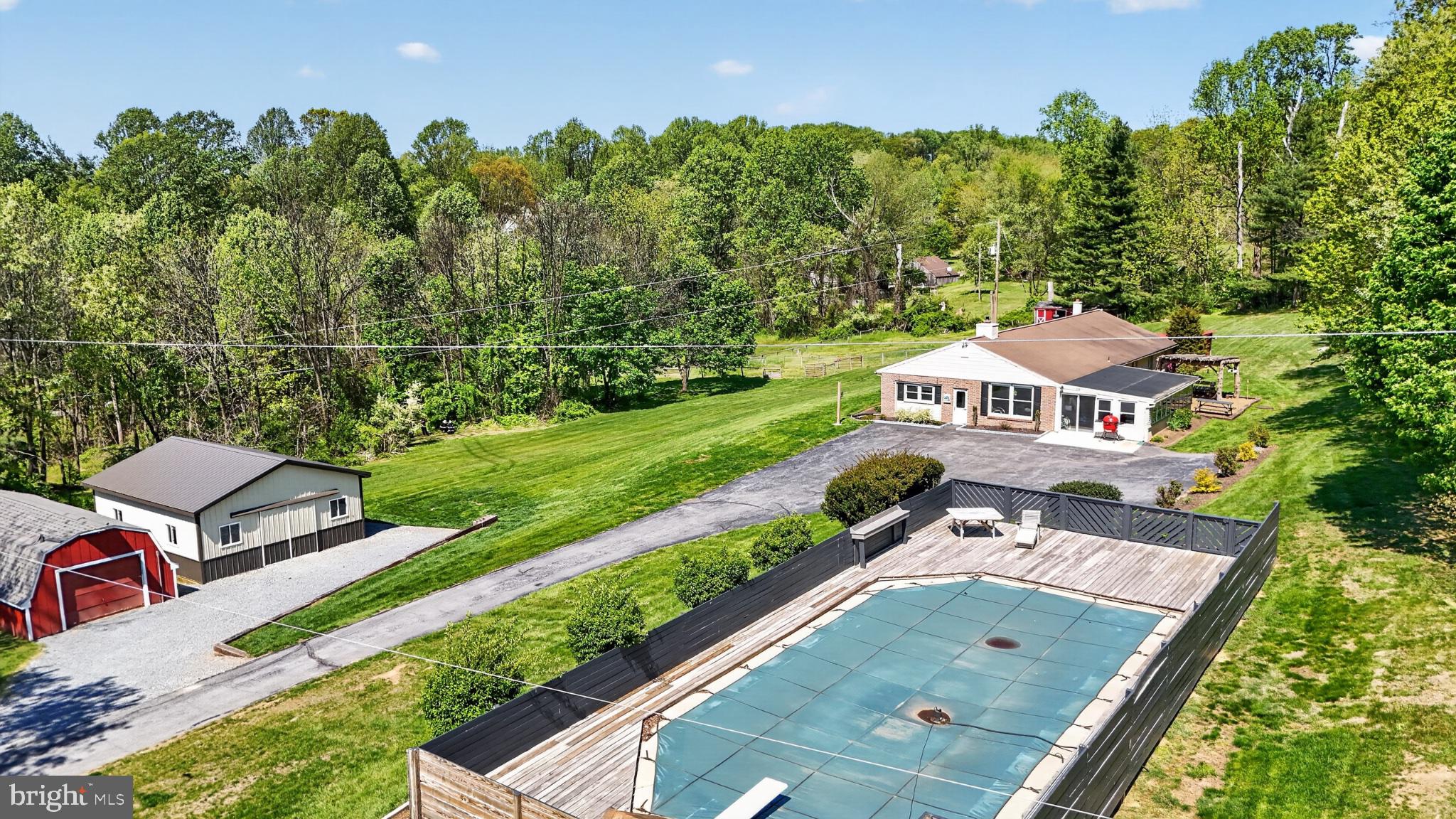**This property will be offered at Public Auction on June 30, 2026 @ 6:00 PM. The listing price is the suggested opening bid only and in no way reflects the final sales price. $55,000 Deposit due on auction date. 2% transfer tax to be paid by the purchaser. Settlement on or before August 28, 2026.**Discover the serenity and sophistication of **Honey Brook Hideaway**, a breathtaking 4.7-acre private estate nestled in the rolling countryside of Honey Brook, Pennsylvania. Completely refreshed in 2023, this meticulously updated home features elegant living spaces with abundant natural light, three spacious bedrooms, three baths, rich hardwood finishes, a stunning stone fireplace, and a gourmet kitchen with premium appliances. Step outside to your own resort-style oasis featuring an expansive 18x43 in-ground pool, lush manicured lawns, a newly built 24x27 horse barn, multiple outbuildings, and endless recreational space perfect for gardening, entertaining, or simply unwinding in nature. Whether you're seeking a peaceful family retreat or a gentleman's farm, this turnkey property offers the perfect blend of modern luxury and timeless countryside charm. Don't miss your opportunity to own this rare gem at auction on June 30th.