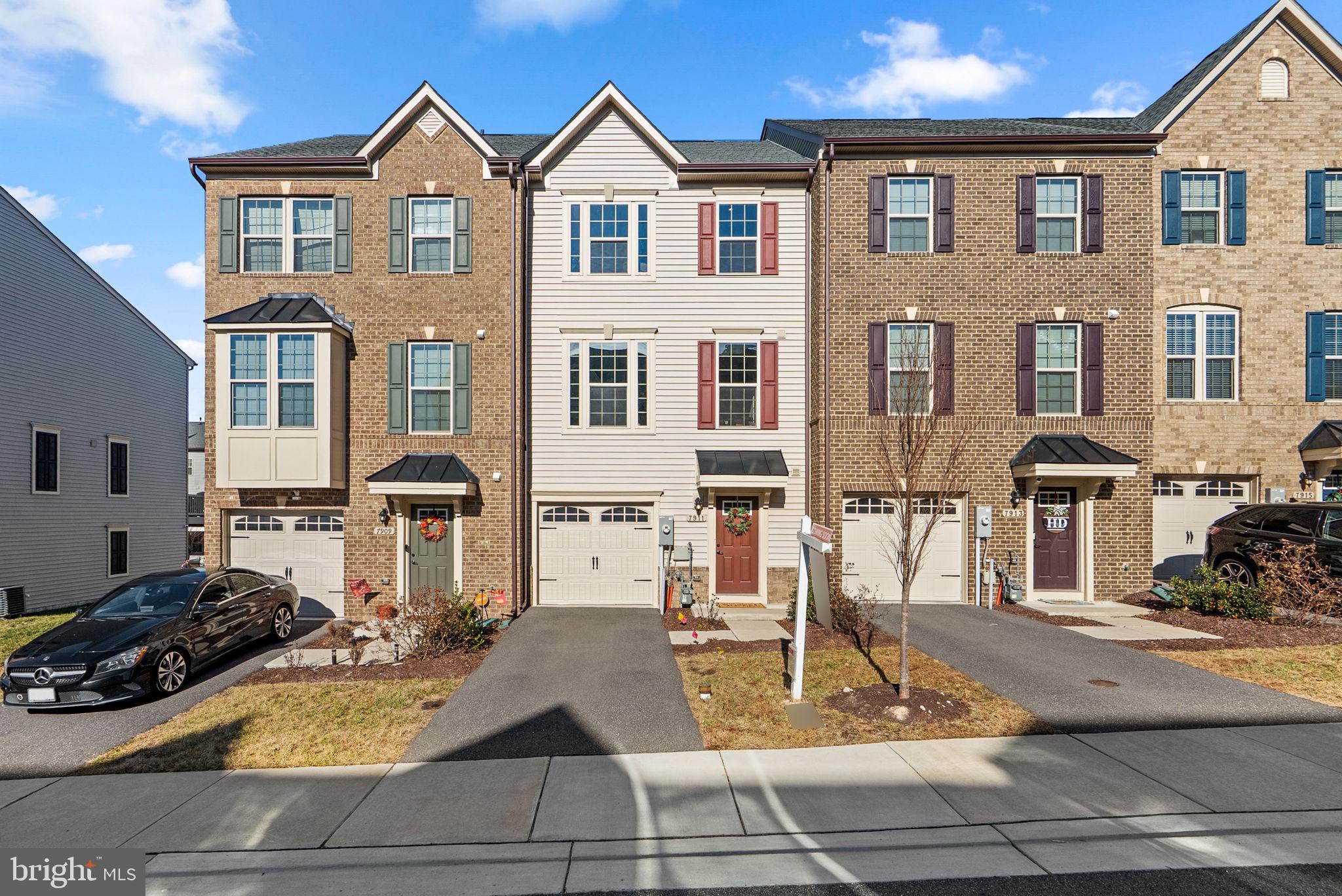 Inviting townhouse residence offering 3 bedrooms, 2 full bathrooms, 2 half bathrooms, and 1,960 finished square feet, ideally located in welcoming Parkside. The entry-level foyer leads to a versatile recreation room featuring a convenient powder room and walk-out exterior access, providing flexible space for entertaining, relaxing, or working from home. Luxury vinyl tile flooring flows throughout the open-concept main level, which seamlessly combines the living and dining areas and includes an additional powder room. The sleek, bright, and modern eat-in kitchen is designed for both style and function, showcasing an oversized island with breakfast bar seating, upgraded countertops, stainless steel appliances, a subway tile backsplash, a pantry, and a breakfast area with access to the deck. The upper level features three carpeted bedrooms, highlighted by the spacious primary suite with a tray ceiling, a walk-in closet, and a private ensuite bathroom with dual sinks. A second full bathroom and laundry facilities complete this level for added convenience. Residents of Parkside enjoy access to an in-ground community pool, enhancing the lifestyle appeal of this thoughtfully designed home.
