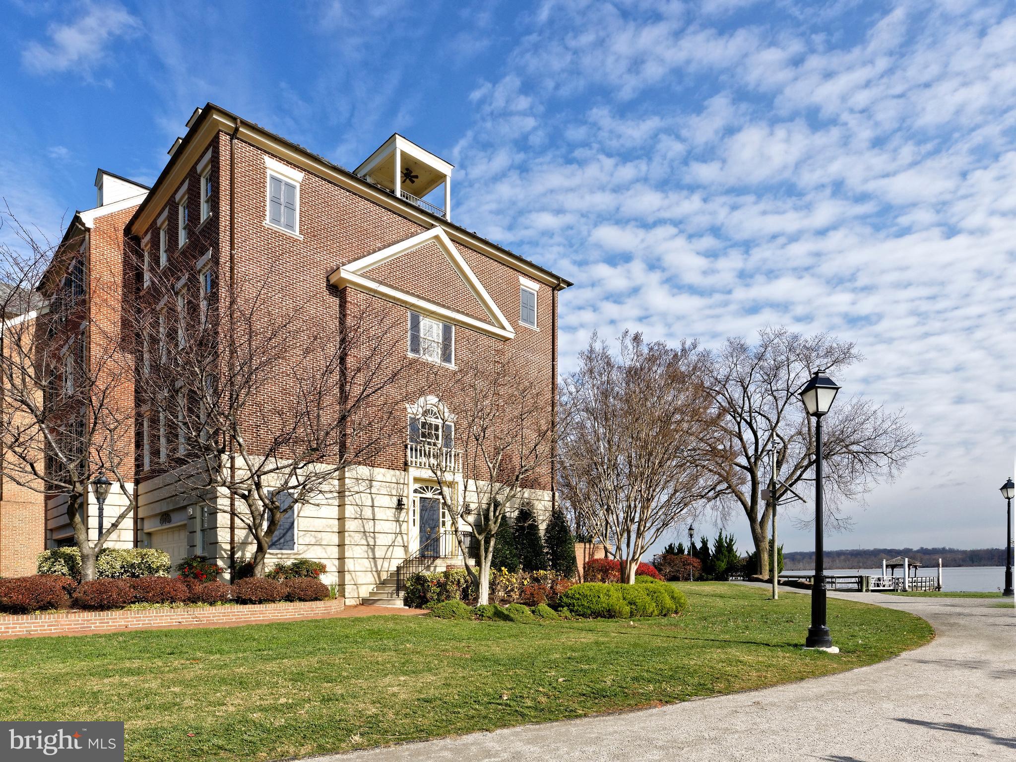 Extraordinary waterfront Harborside end townhouse with sweeping Potomac River views.  4 bedrooms, 4 full and 2 half baths, all bedrooms with ensuite baths and walk-in closets.  Entertaining rooms are spacious and the width of the house with French doors opening toward  the water view.  Other features include a wet bar in the family room, 4 gas fireplaces, a marble entrance foyer and hardwood floors throughout. The master suite offers a sitting area, fireplace, a desk area in front of a southern window plus an enormous marble bath. The top floor balcony provides a wide, exciting view of the river and the park. An attached 2 car garage completes this fine property.