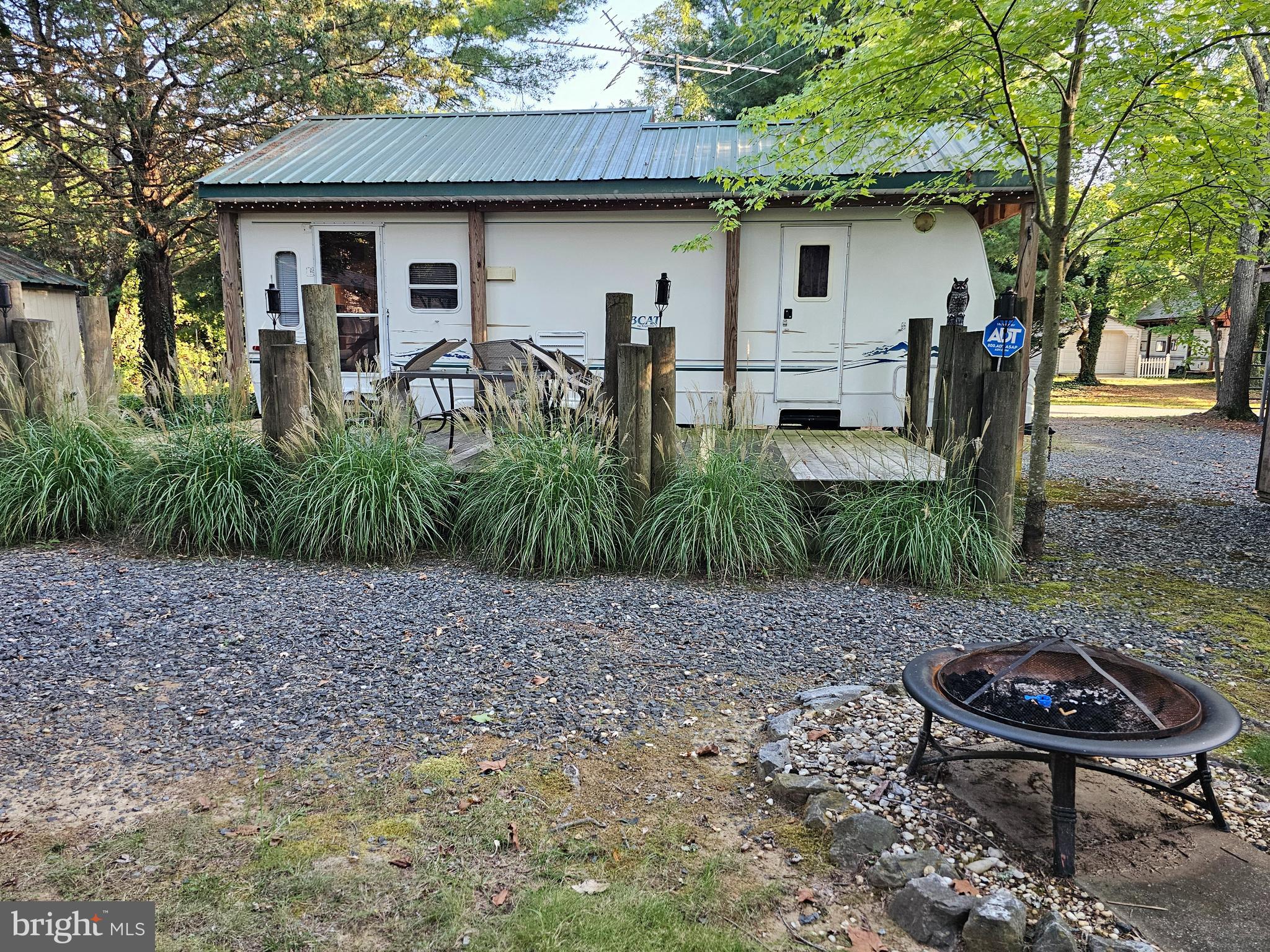 Spacious vacation "funcation" getaway you own. Two lots (5226) sq ft. with 2002 Bobcat trailer (32x8) sleeps 6 with 12ft slide out room with a roof over, deck 12x24, two sheds (1-12x24, 1-8x8), and a car port (12x25). Clean and ready to occupy for the fall season. Community boat ramp, swimming pools, lake, beach, pier and gated entrance into Indian Acres Campground which is limited to 150 days a year no more than 100 consecutive days. Plenty of activities, convenience store, arcade, and community center.