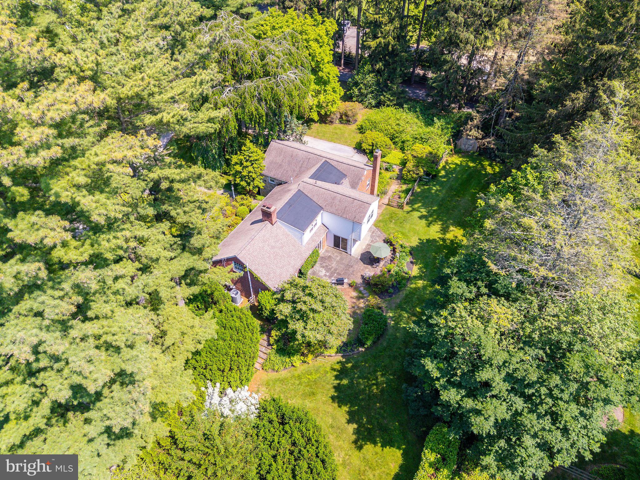 Set on a generous and level 0.89-acre lot in one of Radnor Township’s most desirable neighborhoods, this rare opportunity offers unlimited potential for renovation, expansion, or brand-new construction. Surrounded by established estate homes and located within the award-winning Radnor School District, the setting alone makes this a compelling offering for both homeowners and builders.

This home’s position—on the highest elevation along Parkes Run Lane—enhances its privacy, natural light, and separation from surrounding properties. The existing stone and brick multi-level Cape features 4 bedrooms, 3 full and 2 half baths, and a flexible floor plan with distinctive architectural elements. The living room is highlighted by a vaulted ceiling, custom built-ins, and a fireplace. The formal dining room opens to the rear patio through sliding glass doors, as does the adjacent kitchen, which includes a breakfast area and a large walk-in pantry. A powder room is located just off the foyer.

A few steps from the kitchen is a spacious family room with another fireplace, built-ins, and wet bar—plus interior access to the two-car garage and an adjoining solarium with greenhouse-style windows. Below that, a partially finished lower level offers an office, half bath, laundry area, and ample storage.

Optimally located near top-ranked schools, the train, and downtown Wayne, this property offers the flexibility to reimagine the existing home or create a custom new residence from the ground up—all in a quiet, elevated position within one of the Main Line’s most prestigious neighborhoods.