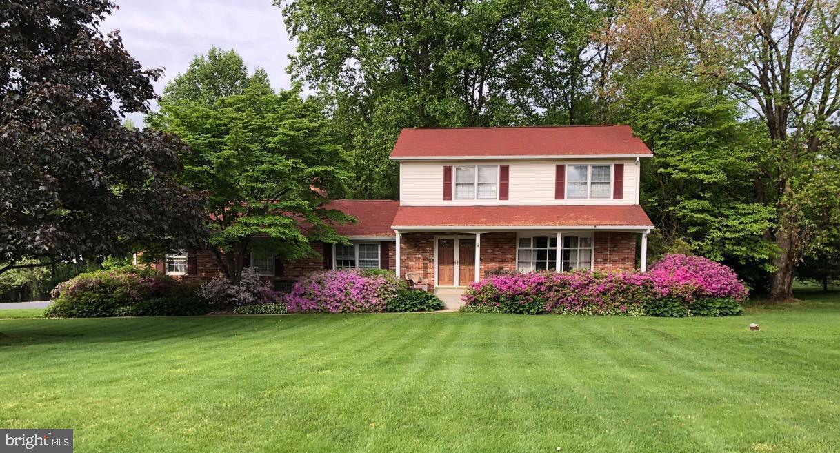 Custom well built home coming to the market!   3 bedrooms, 2.5 baths, 2 car garage featuring 3 finished levels on over an acre with mature trees and an incredible handicap accessible deck to enjoy it all.  Over 2500 sq feet of home with gleaming hardwoods, sundrenched windows, kitchen with newer stainless appliances opening into a dine in area and open to the family room with a woodburning fireplace.  Freshly painted throughout and 2.5 newly updated bathrooms add value here on Spring view.  A formal dining room and large sunfilled living room with big bay sitting window welcome guests and make entertaining an absolute breeze.    Pocket doors seal off the kitchen from the living room and dining area.  The 2nd floor bedrooms feature hardwoods, oversized closets and the large primary bedroom has a walk in closet with shelving and ample storage.  Two full bathrooms and overhead attic storage space with a whole house fan round off the thoughtful upstairs space.   The lower level has a finished rec room with a very large storage area, utility room, laundry center and bilco doors to walk out to the back yard.  This lovely home is incredibly well maintained with recent additions such as new ceiling fans and light fixtures as well as freshly polished hardwoods throughout the home.   The rear of the home is relaxing and serene with a screened in porch and deck making entertaining an absolute breeze.  A handicapped accessible ramp allows guests to enter via the screened porch into the very ample double doors to the family room space.  There is plenty of room to park guests with a 2 car garage, extended pad and freshly sealed blacktop drive.  Note the gorgeous azaleas, flowering dogwoods, huge mature trees, perennial flowers, playset and relaxing front and backyard space.