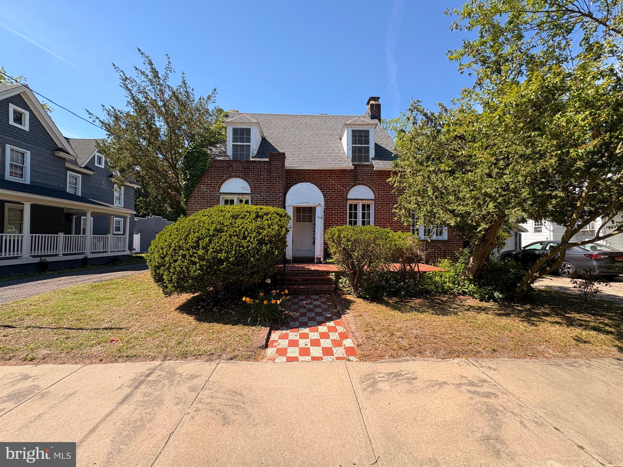 Step back in time with this enchanting 1935 brick Cape Cod  situated in a sought-after neighborhood ideal for college rentals. This three bedroom, one bath home, retains all of its original charm with beautiful hardwood floors, detailed moldings, and elegant casement windows offering a classic, timeless character in every room. The spacious living room features a lovely brick wood-burning fireplace accented by matching sconces and  a new Mitsubishi mini split ac unit for added modern comfort. An adjacent bonus room can be adapted as an office or additional bedroom, offering flexible options. The kitchen  preserves its vintage charm featuring a classic sink, stove and dishwasher, along with a beautiful built-in storage cabinet.  Access to the full  basement is conveniently located through the kitchen and the back entrance. Upstairs two of the three bedrooms have  beautifully sloped  ceilings and dormers. The third bedroom includes its own bathroom sink tucked neatly in the corner adding a convenient and private touch to the space. The full bathroom exudes vintage charm with penny tile flooring, original  cast iron bathtub and built in storage. There's also a wooden panel door at the top of the stairs giving direct access to the bathroom plumbing. Outside,  the home is framed with custom brick sidewalks and hardscaping along with beautiful trees and lush shrubs. A shared garage with two additional parking spaces in the shared driveway provides ample parking space. The architectural shingled roof was replaced within the last five years. This home is a rare find, brimming with original character and charm - perfect for a college rental, a family home, or a buyer ready to restore its timeless appeal.