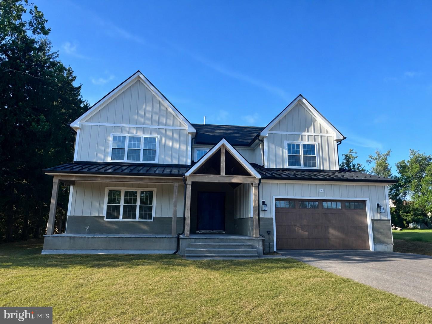A rare opportunity to own a truly exceptional custom-built residence where timeless craftsmanship, modern architecture, and meticulous attention to detail come together. Nearing completion, this stunning home offers over 4,000 square feet of luxurious living space plus approximately 1,600 square feet of finished lower-level space. Designed with no cookie-cutter floor plan, every element of this home has been thoughtfully customized with superior materials, elegant finishes, and exceptional quality throughout.
From the moment you arrive, the impressive exterior makes a statement with board-and-batten siding, a welcoming blue stone walkway and front porch, and an elegant double front entry door. Step inside the dramatic two-story foyer and experience the open, sophisticated design that flows throughout the home.
The first floor offers a perfect balance of elegance and functionality, featuring a spacious and light-filled living room, a private home office, and a breathtaking two-story family room with a contemporary electric fireplace, custom fluted feature walls, and expansive sliding glass doors leading to the rear porch and backyard. The formal dining room is enhanced by a custom dry bar, creating an ideal setting for entertaining.  The heart of this home is the spectacular designer kitchen featuring custom cabinetry with extensive storage, premium leather-finished countertops, an oversized center island with additional cabinetry, stainless steel appliances, and a spacious eat-in area. Designed for both everyday living and entertaining, this kitchen combines beauty and functionality. The second floor features a luxurious owner’s suite designed as a private retreat, complete with a spa-inspired bathroom and an oversized walk-in closet. An additional bedroom offers its own private bathroom, while two spacious bedrooms share a beautifully appointed hallway bath. A conveniently located second-floor laundry room adds everyday convenience. Superior craftsmanship is evident throughout, featuring 9-foot ceilings, premium wide-plank white oak flooring throughout the home, over 100 recessed LED lights, a dramatic custom floating staircase, deluxe energy-efficient windows, 2x6 exterior wall construction, full spray foam insulation, a comprehensive waterproofing system, two-zone heating and cooling, and more. Every detail reflects a commitment to comfort, efficiency, and long-lasting value. The finished lower level provides approximately 1,500 square feet of additional living space with 9-foot ceilings and a full bathroom, offering endless possibilities for a recreation room, home theater, gym, guest accommodations, office, or additional entertaining space. This beautifully finished area expands the home’s versatility and provides the perfect space for today’s modern lifestyle. Located in the highly sought-after Council Rock School District, this remarkable custom residence offers the rare combination of luxury, craftsmanship, energy-efficient construction, and personalized design. This is more than a home—it is a thoughtfully crafted statement of quality and sophistication created for buyers who appreciate exceptional living.