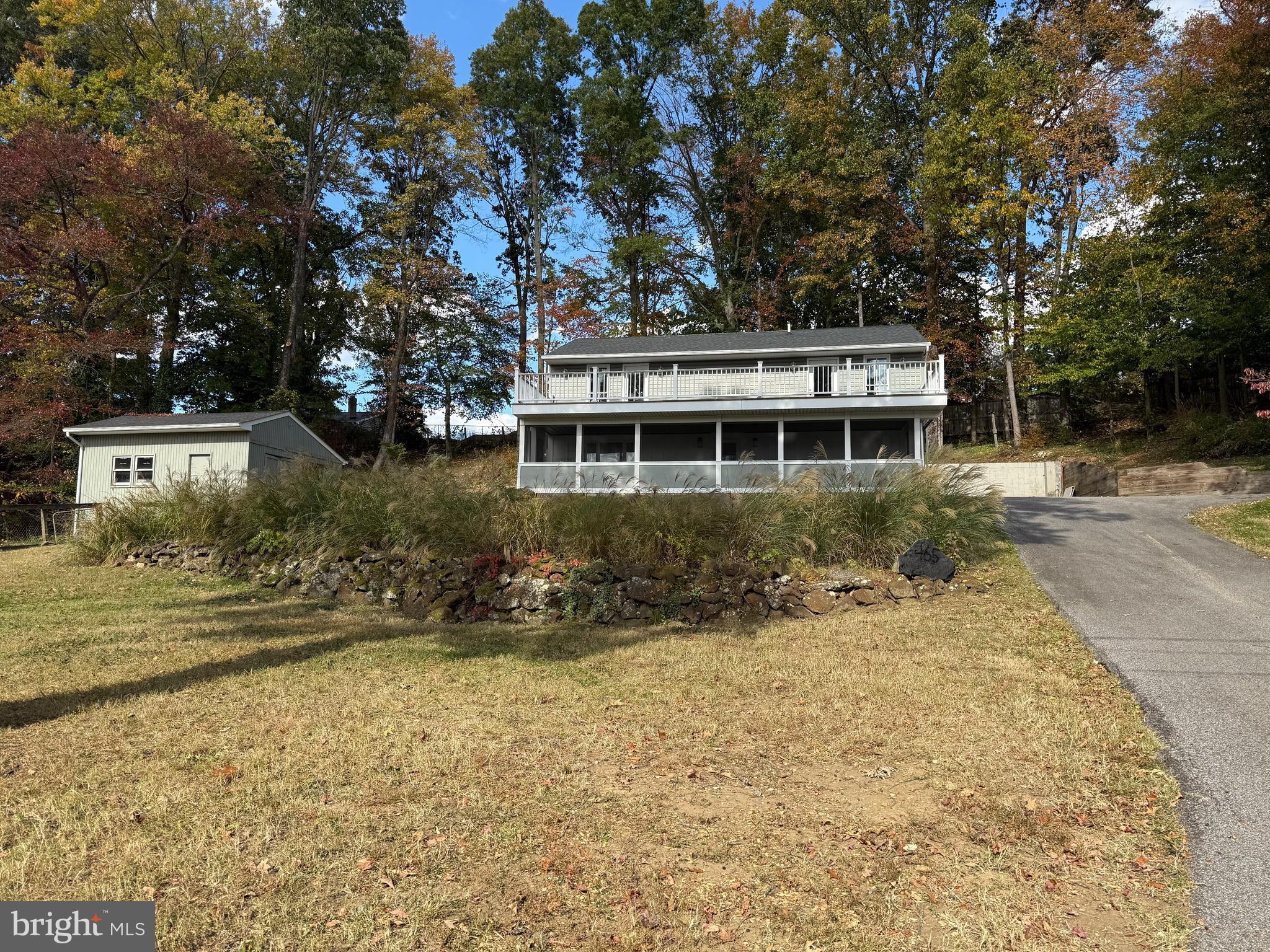 FULLY RENOVATED HOME ON THREE LOTS IN WATER-ORIENTED COMMUNITY OF LOCH HAVEN BEACH! WELCOME TO THIS BEAUTIFULLY 3 BEDROOM POTIENTIALY 4 BEDROOM JUST ADD A DOOR. CURRENTLY CAN BE USED AS COMMUNITY OR BONUS  ROOM WITH DOOR EXITS ON TO DECK,  3 1/2 BATHS WITH PEACEFUL SETTING. EACH BATHROOM OFFERS LIGHT AND VENT FIXTURES EQUIPPED WITH BUILT IN BLUETOOTH SPEAKERS, ALL BEDROOMS HAVE SMOKE DETECTORS HARDWIRED WITH BATTERY BACKUP, SHED AND ATTIC PULL DOWN WITH BLOWN INSULATION ADDITIONAL ELECTRICAL WIRING POTENTIAL GARAGE OR PRIMARY BEDROOM. ENTER INTO THE OPEN MAIN LEVEL BRAND NEW LUXURY VINYL PLANK FLOORING, NEW ROOF, NEW HVAC SYSTEM, NEW WATER TREATMENT SYSTEM PROVIDING MODERN STYLE AND PEACE OF MIND FOR YEARS TO COME. COMMUNITY AMENITIES; PLAYGROUND, BASKETBALL, TENNIS, PICKLEBALL & VOLLEYBALL COURTS, BOAT RAMP WITH WATER ACCESS AND PICNIC AREA. THIS MOVE IN READY HOME OFFERS THE PERFECT BLEND OF COMFORT, RECREATION, AND NEIGHBORHOOD CHARM!!