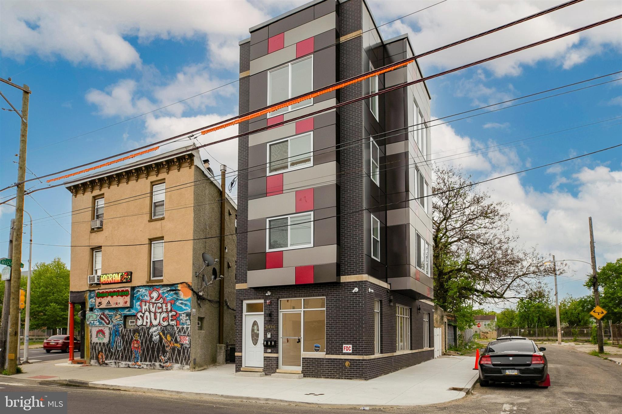 Investor Alert! New construction mixed-use triplex in North Philadelphia West. Unit 1 is a ground-floor commercial space featuring a finished basement, oversized windows, neutral flooring, sprinkler system, fire detection system, and a private exit door to a fenced backyard with separate street access. Located minutes from Temple University, SEPTA transit access, parks, and major highways. The property benefits from a transferable 10-year tax abatement with approximately 7 years remaining as of the date of listing, buyers are strongly encouraged to independently verify the abatement status and remaining term with the City of Philadelphia prior to settlement. Building generates approximately $58,000 in annual rental income across all units.