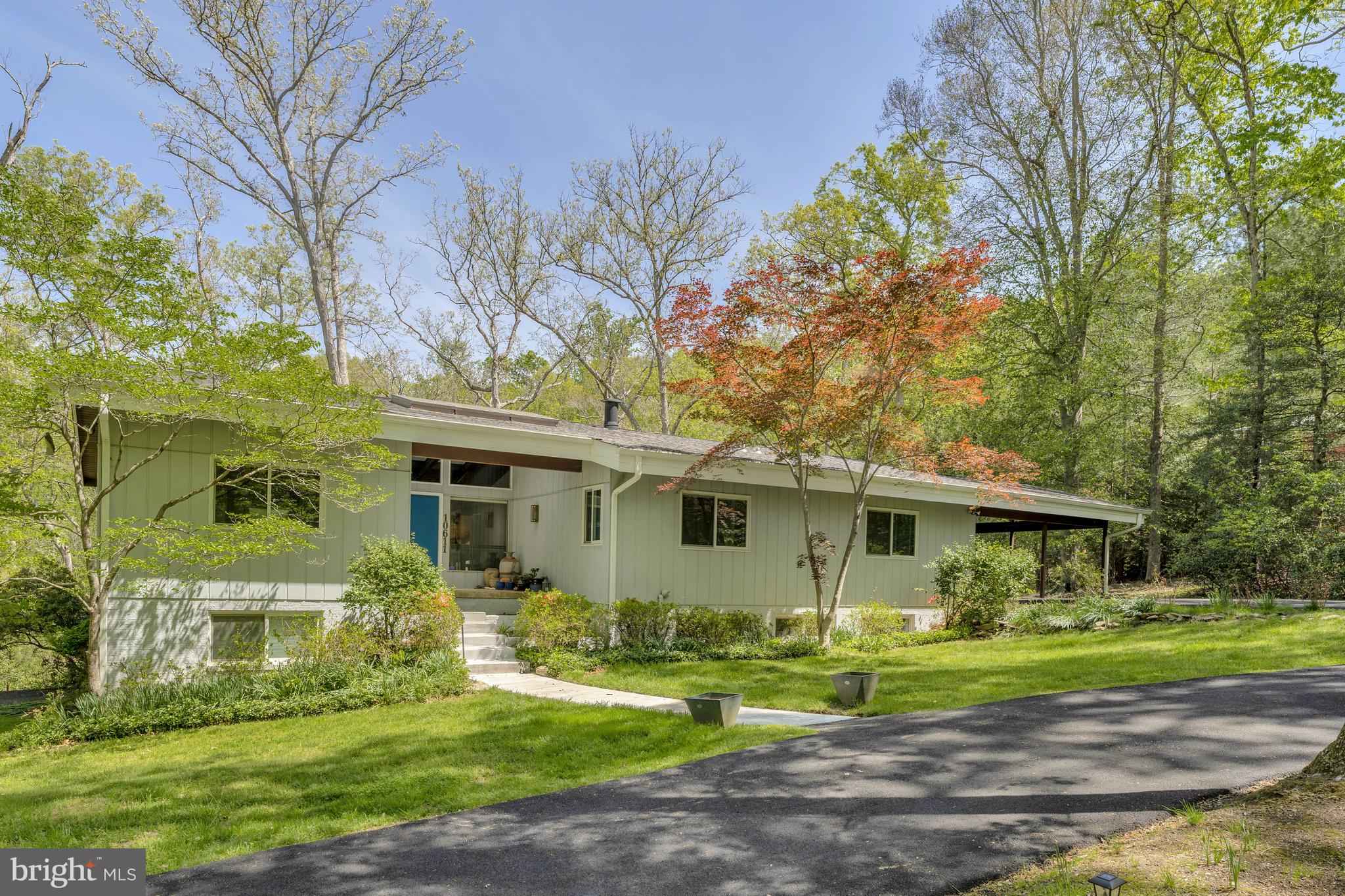 Welcome to this custom-designed deck-style residence inspired by the timeless principles of Frank Lloyd Wright. Nestled on over five private acres, this extraordinary 6-bedroom, 4-bathroom home offers breathtaking views from every window—bringing nature into daily living in the most serene way. At the heart of the home is a brand-new kitchen, thoughtfully designed with today’s lifestyle in mind—offering fresh, modern finishes and a beautiful gathering space that complements the home’s architectural character. All bathrooms have also been fully renovated, providing a cohesive blend of comfort and contemporary style throughout. Cedar cathedral ceilings and walls of glass fill the interior with warmth and natural light, while expansive living spaces flow effortlessly outdoors. Cedar cathedral ceilings and expansive glass create warmth and light throughout, while thoughtfully designed living spaces flow effortlessly to the outdoors. Step outside to enjoy your own private pond and the tranquil beauty of Nicholas Run bordering the property, enhancing the peaceful, retreat-like setting. Mature trees and natural woodlands surround the home, offering privacy and a true connection to the landscape. Located just around the corner from L’Auberge Chez François and moments from the heart of Great Falls, the property is also adjacent to parkland maintained by The Nature Conservancy, with 233 acres along the Potomac River and miles of scenic hiking trails. With its dramatic yet welcoming interior, expansive decks and patio spaces, renovated kitchen and baths, private pond, and the natural beauty of Nicholas Run, this home is a rare sanctuary—perfect for both elegant entertaining and peaceful everyday living.