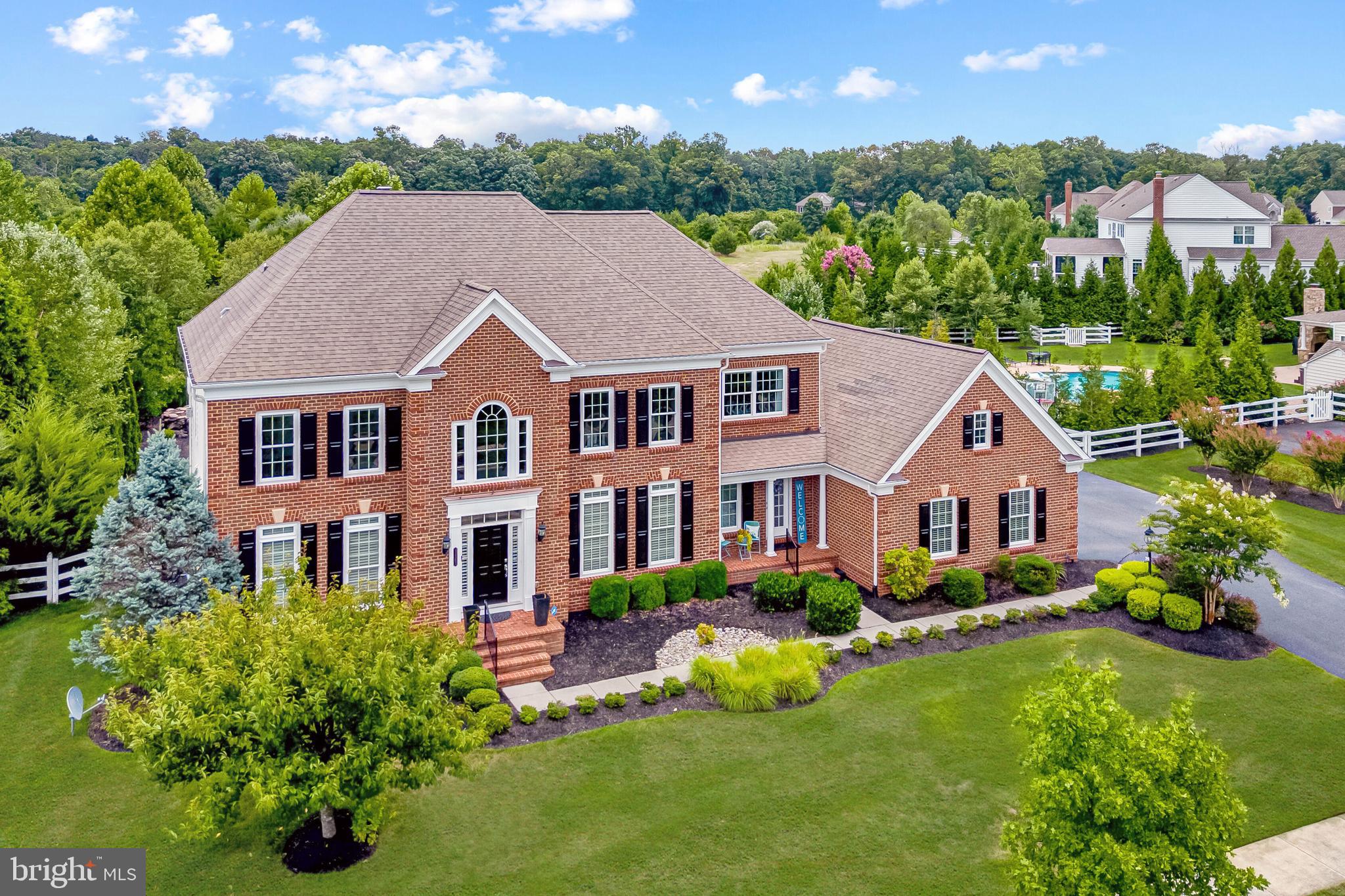 Welcome to your ultimate dream home, where luxury meets comfort year-round! This magnificent colonial estate is nestled on a professionally landscaped .48-acre lot, backing to over 100 acres of conservancy space, and situated in a neighborhood renowned for its distinction and charming tree-lined streets. Boasting nearly 5,700 square feet of opulent living space, this residence features five bedrooms and four-and-one-half bathrooms.   
<br><br>
Indulge in your backyard sanctuary, fully fenced and featuring a private in-ground gunite pool with a captivating water fall and inviting heated spa.  Spend leisurely evenings gathered around the firepit or unwind beneath the sheltered patio with a cozy fireplace, watching movies or sports on the top-of-the-line, all-weather TV, while serving guests and family from the well-appointed patio kitchen.  The outdoor experience in this home is carefully crafted to offer unparalleled relaxation and entertainment.   
<br><br>
Inside, the grand two-story foyer welcomes you, flanked by formal living and dining rooms. Meticulous design features and modern fixtures adorn the main level, boasting 10’ ceilings and hardwood floors throughout. Gather in the family room with its cozy fireplace and dramatic coffered ceiling. The fully renovated gourmet kitchen is a chef’s delight, equipped with top-of-the-line appliances, upgraded quartz countertops, a spacious center island with seating and storage, coffee bar, pendant lighting, farmhouse sink, and more. A convenient home office and a large laundry room featuring a utility sink and separate exterior entrance complete the main level.   
<br><br>
Ascend to the upper level and find four generously sized bedrooms, including the primary suite, accessed through elegant French doors. This serene retreat encompasses a spacious sitting room adorned with a gas fireplace, a bespoke walk-in closet, and a fully remodeled luxurious spa-like bathroom. Additionally, there's a princess suite boasting its private bathroom, while two other bedrooms share a convenient jack-n-jill bathroom, offering ample space for family and guests. Plush carpeting, ceiling fans, and generous closet space grace all secondary bedrooms, ensuring comfort and convenience for all occupants.   
<br><br>
Discover additional living space in the finished walk-up basement, perfect for entertaining or accommodating guests. This expansive area includes a media room for movie nights, the fifth bedroom for added privacy, and the fourth full bathroom for convenience. Indulge in refreshments at the classic pub bar, engage in friendly competition in the game room, or unwind in the cozy den. Stay active in the gym, ensuring you can maintain your fitness routine year-round. With amenities tailored for comfort and relaxation, the basement provides an ideal retreat for extended family or guests, offering both privacy and comfort.   
<br><br>
Nestled in a serene countryside backdrop, yet just moments from the vibrant hubs of historic downtown Leesburg, Brambleton Town Center, and the Silver Line Metro, this residence presents the epitome of convenience and tranquility.  Revel in the plethora of dining, shopping, and entertainment options just a short drive away, knowing you can return home to the peaceful ambiance of Red Cedar.  Enjoy the neighborhood amenities, including tot lots, a charming village green, and a refreshing community pool.  Welcome home to the perfect balance of suburban serenity and urban convenience.
