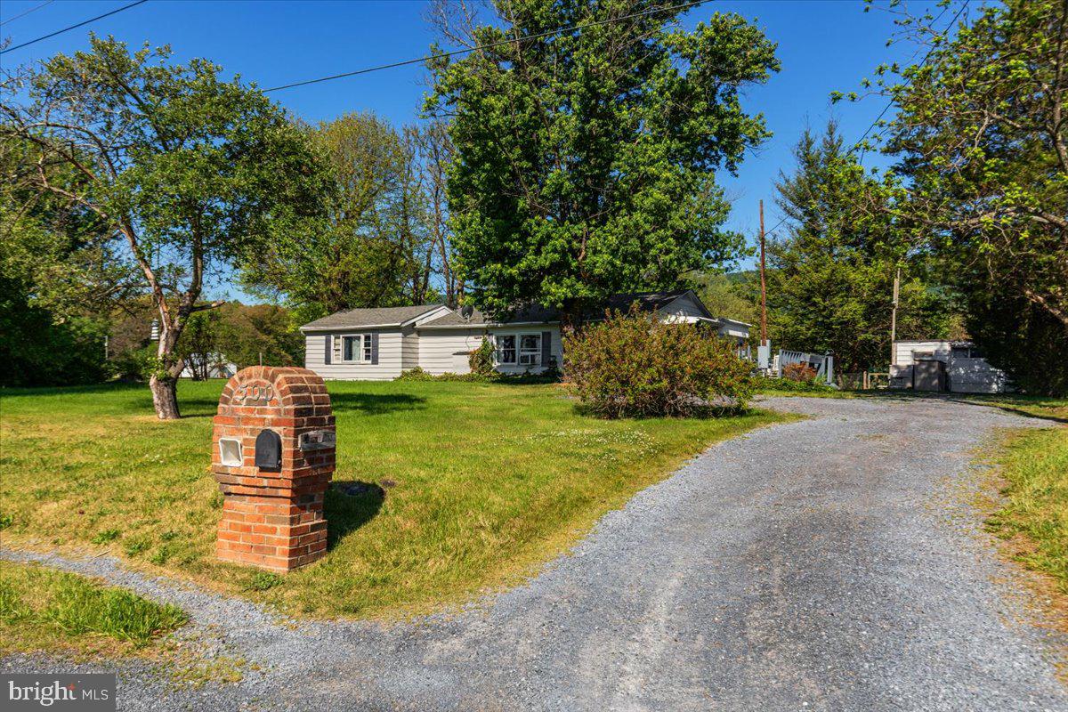PRICE IMPROVEMENT ALERT!!   Nestled in a peaceful country setting just minutes from Winchester, this property offers an incredible opportunity to enjoy scenic mountain views and beautiful surrounding pasture land on a picturesque half-acre lot. The setting is truly the star here, with open views in the front and mountains stretching across the backdrop. Conveniently located with easy access to shopping, dining, and commuter routes while still offering the charm of rural living. Home is being sold strictly AS-IS.
