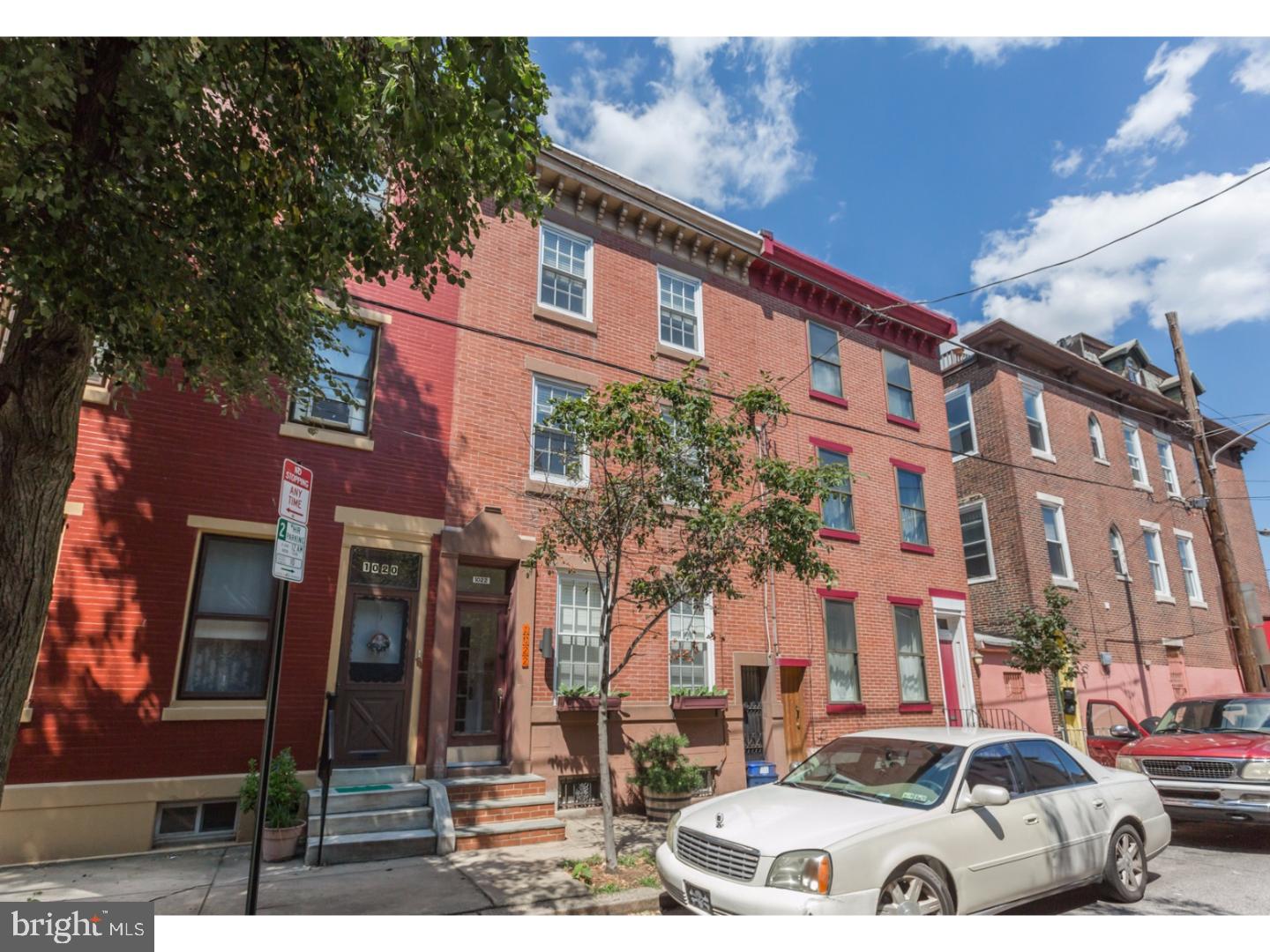 Incredible energy efficient Northern Liberties home with tremendous curb appeal nestled on a quiet, tree-lined street close to everything the neighborhood has to offer. This 5 bedroom, 2.5 bath home has the original red pine hardwood floors throughout, and has been recently renovated to provide modern high end efficiency while still retaining it's old world charm. Enter through the vestibule that boasts original tile work on both the door and entryway into the sunlit living room that is filled with character including beautiful window casings, high ceilings and grand winding staircase that continues throughout the home. Also on the first floor, you will find a sleek powder room with contemporary fixtures and unique translucent backlit floors. The spacious kitchen and dining area has modern cabinetry, handsome tilework, exposed brick, and is beaming with natural light from the numerous windows. Step outside and onto the large patio that is perfect for entertaining, grilling, or just lounging in the fresh air. On the second floor you will find two generously sized bedrooms including the master suite, which has a walk-out balcony, a walk-in closet, and a luxurious master bath with Modwalls tiles, twin sinks, spacious glass door shower, & Grohe fixtures. The third floor has two more bedrooms along with an updated full bath and smaller third bedroom/den. The solar panel array that is located on the roof provides one-third of the total electricity for the home. For heating and cooling, there is a high efficiency dual zone Mitsubishi system that includes 6 total units situated throughout the home. Schedule your showing today, this one won't last long!