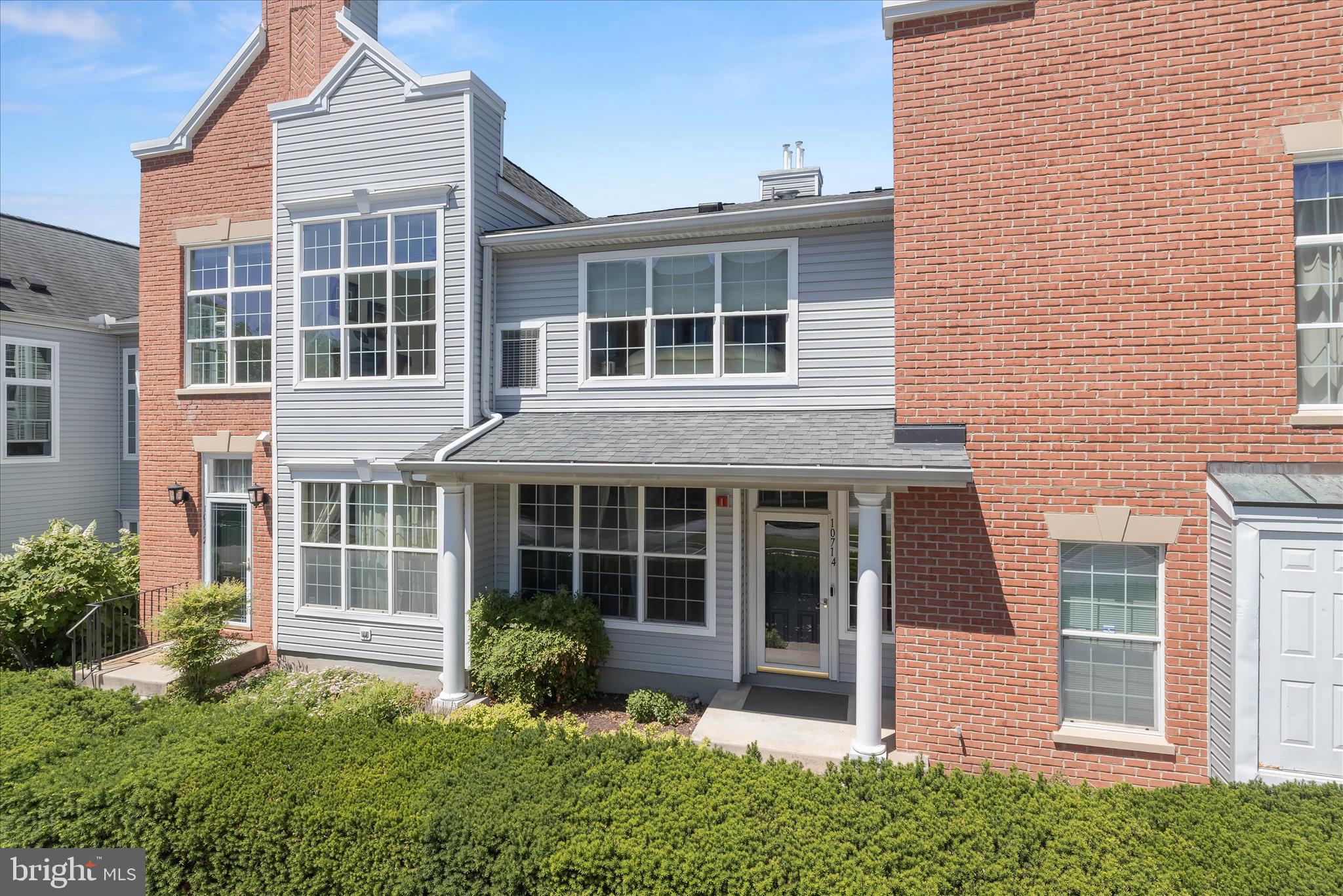 Gorgeous townhome-style condominium located in the desirable community of The Whitney of Town Center, offering bright, spacious interiors and soaring ceilings that create an immediate sense of openness and light. A convenient main-level entry provides access to the attached garage along with a welcoming coat closet for everyday ease. Upstairs, the main living area unfolds with dramatic ceilings and an airy living room that flows seamlessly into a charming sitting area framed by oversized windows and elegant stately columns.
The dining area and kitchen are designed for both comfort and functionality, featuring a breakfast bar, stainless steel appliances, pantry, and an in-unit laundry room. The spacious primary suite offers a private retreat complete with a sitting area, generous walk-in closet with custom organizers, and an en-suite bath featuring a soaking tub and glass-enclosed shower. A second sun-filled bedroom includes its own custom-organized closet and is served by a full hall bath, completing this well-appointed home. Enjoy the ease of low-maintenance condominium living in a vibrant, walkable setting just moments from shops, restaurants, and entertainment. Stroll to nearby dining and retail, catch a film, or enjoy live performances at Merriweather Post Pavilion. With scenic walking paths, lakes, parks, and endless amenities nearby, this home delivers an exceptional blend of comfort, convenience, and lifestyle.