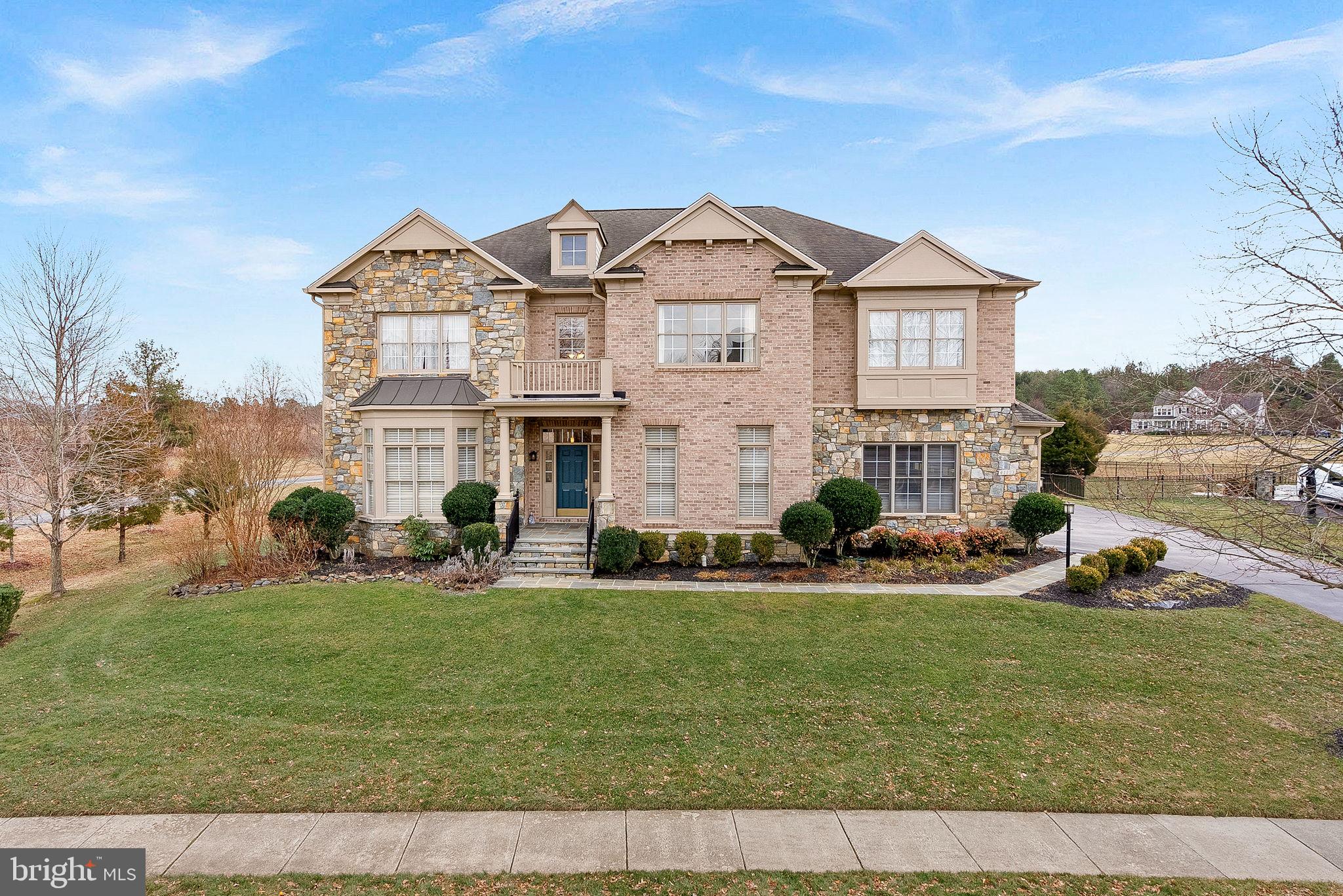 ACCEPTING BACKUP OFFERS! This exceptional four-side brick and stone home built by luxury boutique builder WCI Renaissance is set amidst a 340-acre nature conservancy in the unique community of Greene Mill Preserve. The Grand Botticelli II floor plan is one of their most eye-catching designs with nearly 7,000 square feet of finely crafted living space, circular staircase, coffered ceilings, spectacular architectural features, iron rails and high ceilings. This home offers plenty of privacy with a conservancy lot behind the home and no homes to the left.
 
The two story formal entry with a circular foyer allows for sweeping vistas through the main living level. The dramatic, wrought iron balustrade staircase and two wall niches enhance the elegance and sophistication of the formal foyer from both main and upper living levels. To the right is the dining room and the left the living room. A dry bar is tucked away just beyond the vestibule. Pass through the butler’s pantry which opens up to the gourmet kitchen with center island, upgraded glass front cabinets, cooktop with range hood, Monogram  Advantium double oven, stainless appliances and two separate sinks. The breakfast area features a bowed bay keeping, the perfect finishing touch to a gourmet kitchen. The great room earns its name with the excellently combined elements of a built-in fireplace, coffered ceiling and angled window wall expanding the entire room with outdoor vistas. The large windows along the back of the home overlook the vast conservancy area behind the home. On the other side of the kitchen sits the hobby room with bay window, perfect for an office, homework area or play area and one of two powder rooms on this floor. 

Take the spectacular circular iron-railed staircase to the second floor and enjoy the domed ceiling overhead. Double doors lead you to the owner’s suite, a light-filled private retreat with 9 foot trayed ceiling, a vestibule with step-up to the bedroom area and a comfortable sitting area with an angled gas fireplace. The owner’s bath features a luxurious soaking tub with whirlpool jets, separate shower, two sizeable separate vanities and two walk-in closets. Each of the three large bedrooms on this floor feature direct bath access - one with a private bath - and ample window and closet space. A spacious loft, easily accessed by a private staircase, serves as the perfect office and library with built-in cherry wood shelving and desks. A large laundry room is located on this level. A second set of stairs will take you down to the hobby room next to the kitchen.

The basement is fully finished with all the best features for entertaining guests. There’s an expansive rec room with wet bar (dishwasher & beverage refrigerators), a custom home-theater with screen & projector, a large legal bedroom with full bathroom, & a gym area. Large storage area includes shelving and a gun safe which can convey to the new owner. From the rec room, you can walk-up to the backyard, where you can enjoy the stone patio, the home’s castle-like curves and many beautiful sunsets from your tranquil backyard. Owners have added a 50-amp circuit for future pool and/or hot tub.

Other home highlights include oversized three-car side-load garage, Hunter Douglas plantation shutters,  Silhouette Blinds and wood blinds, security system.

Designed around a charming village green, Greene Mill Preserve features a clubhouse, pool, the Village Green, nature trails, butterfly garden, basketball court, soccer field & tot lot. While it’s the perfect retreat, it’s still close enough to daily conveniences and commuting routes. The neighborhood is a five-minute drive to the Brambleton Town Center with shops, restaurants, grocery store, movie theater & various medical practices as well as the Ashburn Silver Line station and Dulles International Airport. Residents can also enjoy Al and Berni Hanson Regional Park and Reservoir Park both just a short drive from the neighborhood.