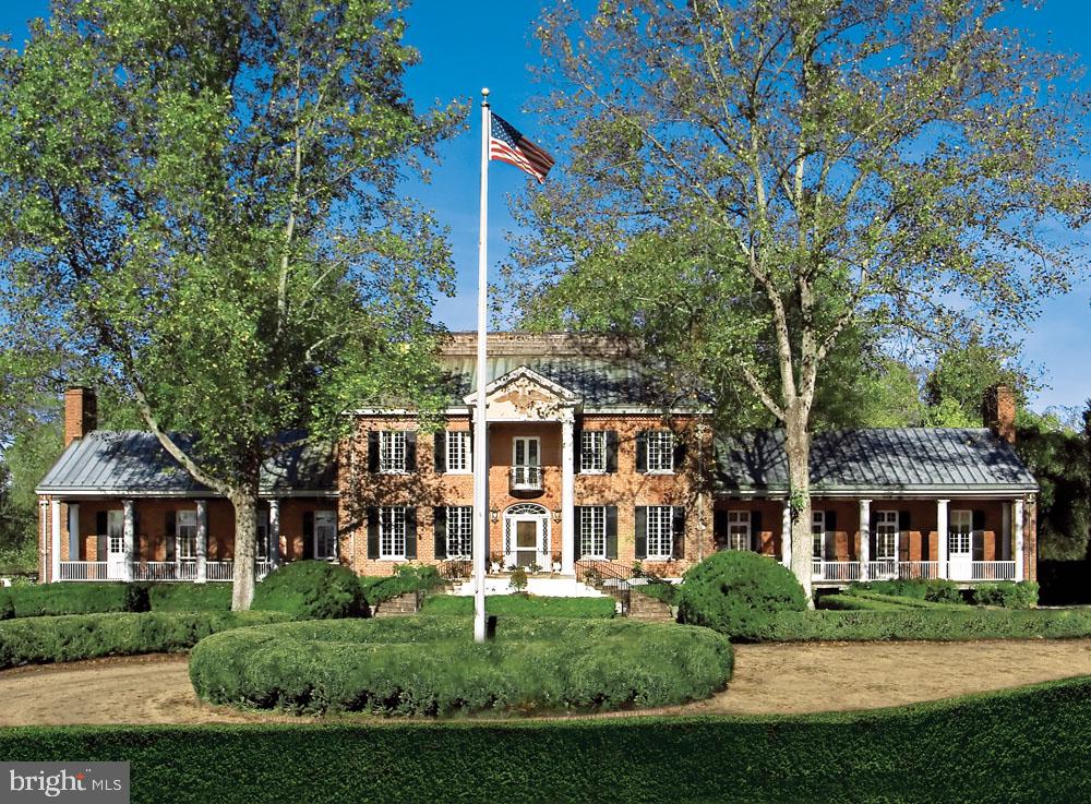 HUNTLAND, ca. 1834, is one of the most remarkable Hunt Country Estates.  Dr. Betsee Parker’s keen interest in historic preservation as well as her love of the countryside surrounding Middleburg prompted her to take on the biggest preservation project of her life: restoring Huntland to its 1915 grandeur. In 2007, when Dr. Parker purchased Huntland, it was in serious disrepair and uninhabitable.  After Dr. Parker’s extensive and meticulous research and after years of work using old world craftsmanship, Huntland is once again the exquisite estate as in the early 1900’s, when owned by Joseph Thomas.  Sited on 129 beautifully landscaped and fenced acres of verdant pastures and fields, Huntland is also a working farm.  Located in the Piedmont Hunt Territory, Huntland has hosted many hunt meets, hunt breakfasts, hunt balls, charity events, and dignitaries including several Presidents. Wanting to protect this estate for future generations, Dr. Parker placed Huntland into a perpetual conservation and open-space easement with The Virginia Outdoors Foundation. Huntland is also registered as a Virginia Historic Landmark and was placed on the National Register of Historic Places in 2013.

Originally named New Lisbon, the 2-story center section of the home dates to 1834 and was built and owned by William Benton. In the early 1800’s Benton was in the employ of President James Monroe who hired him to be the overseer of his Aldie farm of Oak Hill. After observing Benton’s work ethic and attention to detail he also put him in charge of overseeing the building of the manor house of Oak Hill. Benton went on to become a prominent builder in the Middleburg area, and his descendants remained at New Lisbon until 1895.

Joe Thomas, after purchasing this estate in 1912, commissioned Peabody, Wilson & Brown, a prestigious New York Architectural Firm to transform this estate into a world class hunt estate. Prior to addressing the manor house, they were commissioned to design Kennels and Stables to rival the very best in the world. The stables and kennels are magnificent U-shaped buildings with a central square courtyard, built with emphasis for what is best for the hounds, the horses, and the huntsman. It was Joe Thomas who named this estate Huntland, which is not just a name, it is the very essence of this estate. In Marc Leepson’s book, Huntland, he quoted Norman Fine in Foxhunting Life, “Thomas was a founding member of the American Foxhound Club, Master of the Piedmont Fox Hounds, and author of Hounds and Hunting Through the Ages, the first comprehensive book on hunting with hounds ever written by an American. Thomas became the largest breeder of foxhounds for mounted packs in North America and helped to define the American foxhound breed.”

Peabody, Wilson & Brown also designed the renovation and expansion of the original Federal Style home to today’s stately brick Colonial Revival-style mansion. Tremendous amount of attention was given to all details. A south and north wing were added to the 2-story center section, each opening out to a covered porch. The south wing is an impressive primary suite with sitting room, and the north wing is the grand dining room/ballroom. In addition to the manor house, kennels and horse stables, elaborate walls, gates and bridges were added, as well as English gardens, and cottages.

The iconic estate of Huntland has a rich history and with considerable thanks to Dr. Parker, it will enjoy a rich future.  Located in Loudoun County in the exquisite countryside of the Virginia Piedmont, it’s sited at the intersection of Foxcroft Road and Pot House Road. Huntland is approximately 4.5 miles north of Middleburg, within minutes of the prestigious girls school of Foxcroft, and convenient to Dulles International Airport and Washington, D.C. .