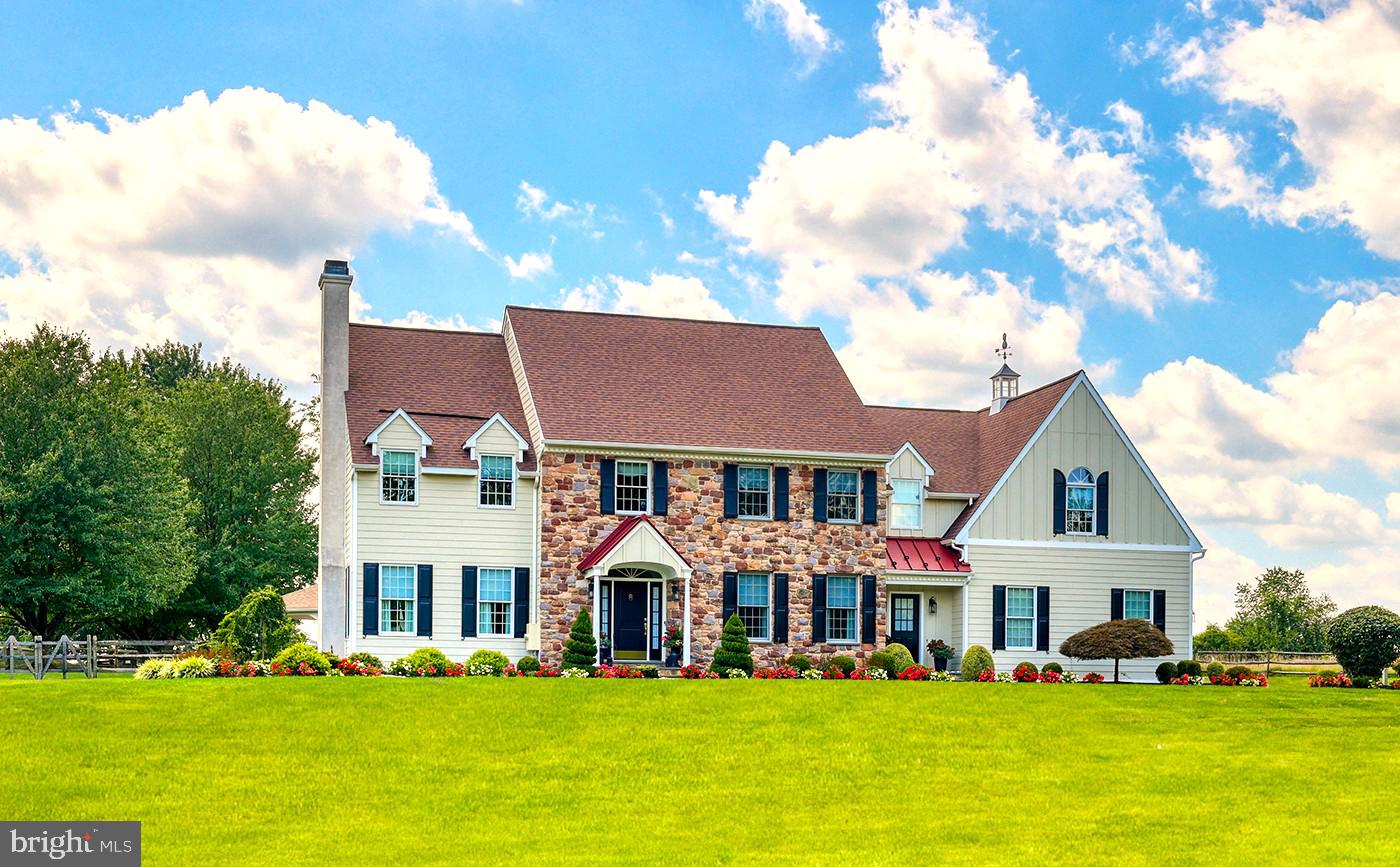 PRICED FOR QUICK SALE! OWNERS DOWNSIZING AND RELOCATING! Discover an exceptional Bucks County retreat at 1100 Pineville Road, set on over two acres of beautifully landscaped grounds just moments from New Hope, PA and Doylestown, PA. A long, private approach framed by mature trees leads to this impressive stone residence, where refined craftsmanship and modern comfort come together seamlessly. Inside, a dramatic two-story entrance sets the stage for sun-filled, inviting spaces. Rich hardwood floors, extensive millwork, and an easy-flow layout create an atmosphere that’s both warm and upscale. The formal living and dining rooms are perfectly suited for hosting, while a quiet, built-in office provides a polished workspace. The chef’s kitchen serves as the home’s central hub, outfitted with custom cabinets, granite surfaces, premium appliances, and a generous island. A bright breakfast area opens to the soaring great room, where a striking stone fireplace and sweeping windows frame views of the property’s resort-style backyard. The second level offers a serene primary suite—complete with dual custom closets, a spa-quality bath, and a flexible sitting area—along with spacious secondary bedrooms and well-appointed bath. The finished lower level adds another dimension to the home with its full bathroom, dry bar, game and billiards space, stacked-stone theater room with fireplace, fitness area, and multiple lounging zones. Whether entertaining a crowd or unwinding at home, this level is designed to accommodate it all. Step outside to your private escape: a heated pool and spa surrounded by lush plantings and thoughtfully designed hardscaping. A covered pavilion with built-in gas grill and refrigerator makes outdoor dining effortless, while several seating areas offer the perfect backdrop for anything from summer parties to quiet evenings under the stars. With a three-car garage, abundant storage, and attention to detail throughout, this home delivers a rare combination of elegance, comfort, and resort-style living. 1100 Pineville Road offers not just a place to live, but a luxurious lifestyle to enjoy every day and is located in award winning Central Bucks School District. The pictures of the sunset from your new back yard oasis…….priceless!