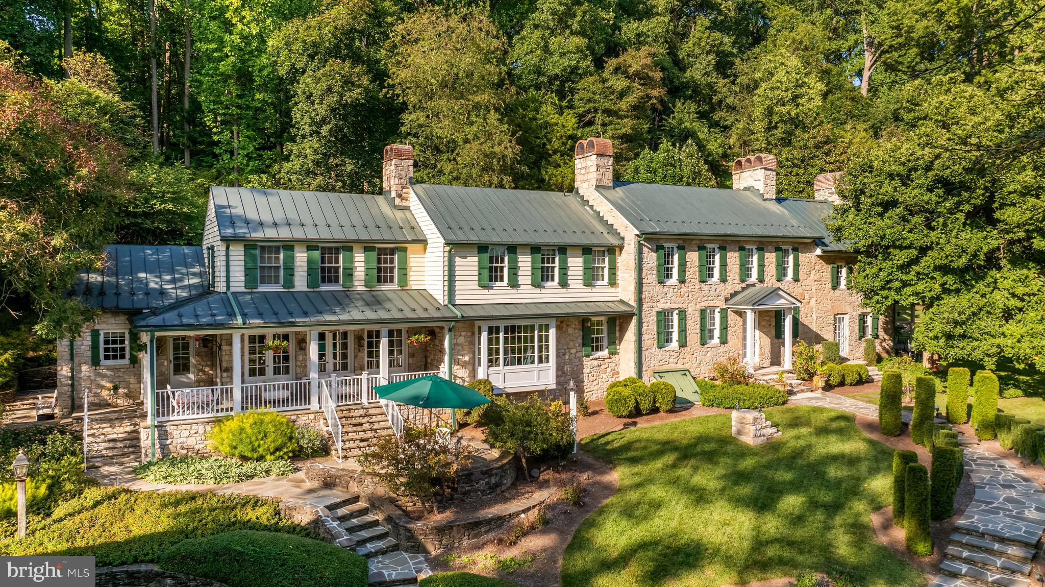 Simply one of Baltimore County's most remarkable estate farms! Beautifully manicured 29 acres in the heart of Western Run Valley. Circa 1821 stone farmhouse has been completely renovated and seamlessly expanded to suit today's modern living, keeping much of it's original charm such as vintage floors and beamed ceilings yet with state-of-the-art systems and high-speed internet. Original Keeping Room with beamed ceiling and oversize stone fireplace. Formal Living Room and Dining Room each with fireplace. Sunny Solarium with heated bluestone floor. Custom fitted Butler's Pantry, Family Room with window wall and stone fireplace flows to gourmet Kitchen. Mudroom, Laundry Room and main level Bath. Primary Suite with Sitting Room and spa Bath with heated floor share the 2nd level with 2 additional Bedrooms, 2 more baths and Office with custom built-ins. 3rd level Bedroom and Bath. Covered porches, patios, terraces, tennis court and an-in ground pool all overlook the Western Run Valley. A storybook 2-story Guesthouse with cook's Kitchen and the 2-story Gym each occupy a thoroughly renovated vintage stone outbuilding. The original stone Bank Barn is equipped as a party barn. Other vintage stone outbuildings include a detached Garage, working Spring House and rebuilt Smoke House. A stunning circa 2017 Barn Complex, built by Amish craftsmen, includes a thoroughly wood-paneled center aisle barn with 4 oversize stalls, tack room, living room, full bath, feed room, utility room , huge loft and oversize sliding barn doors to a tremendous indoor riding arena- perfect for equestrian pursuits or the avid car collector. A third renovated Farmhouse, Tractor/Machine Shed with workshop, Chicken Coop, Animal Enclosure and acres of manicured fenced and watered paddocks. Beautiful gardens with butterflies, pollinating bees and a bird-watcher's paradise including Bald Eagles. All outbuildings have water and electric service and the entire property is impeccably and lovingly maintained.