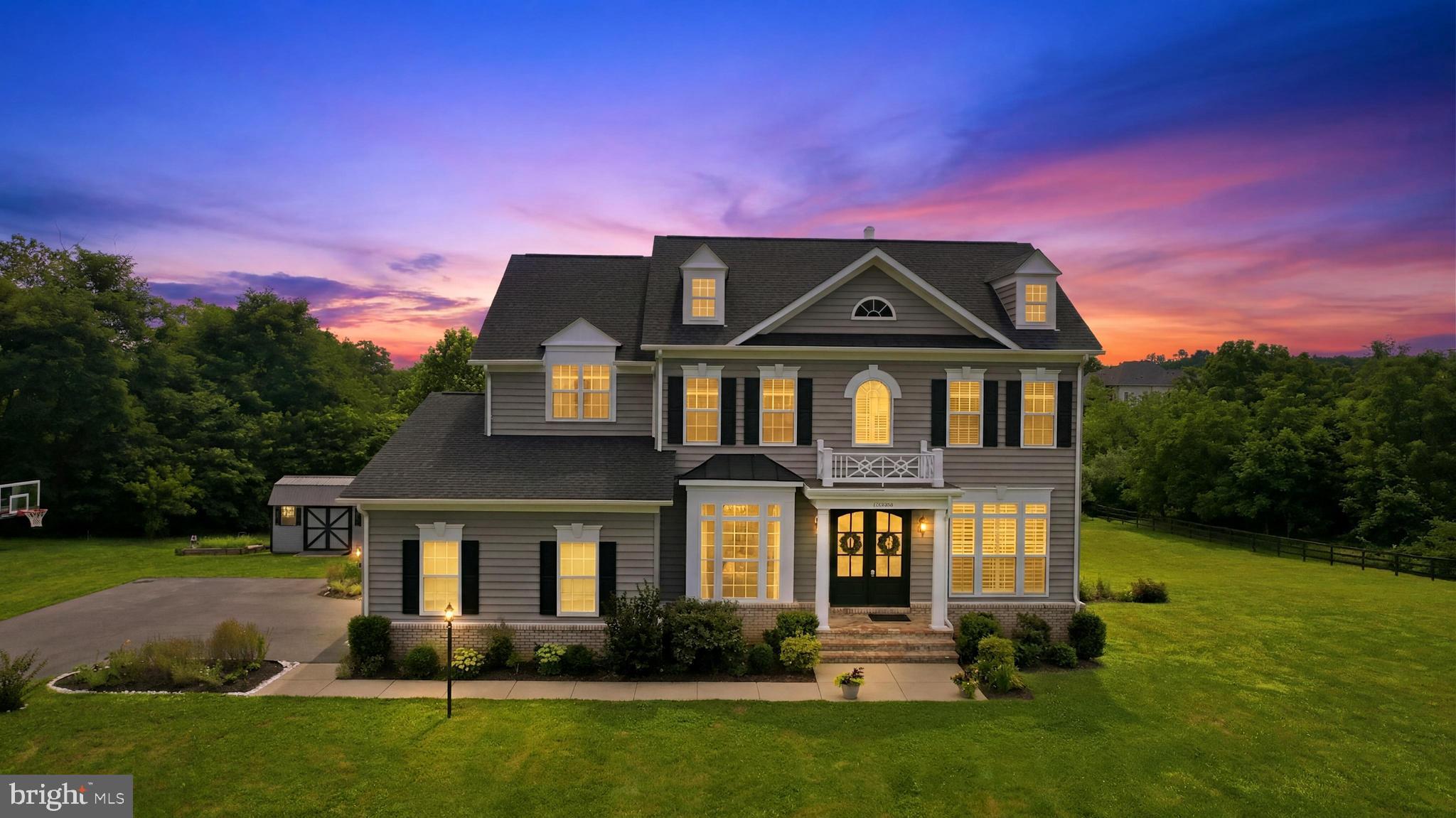✨ Welcome to 12720 Snowbird Court—an exceptional luxury residence in Eagle Creek Estates featuring the highly sought-after Chestnut Grove model by Carrington Homes. 🏡 Set on a premium three-acre lot with no HOA, this coveted estate home offers more than 5,000 finished square feet, five spacious bedrooms, four full bathrooms, and one half bath. Built in 2020, the home showcases exceptional finishes and more than $250,000 in post-closing improvements, including surround sound, a screened-in porch, Trex deck, flagstone patio, and fully fenced backyard.
🌄 Set against the scenic backdrop of the Short Hill Mountains and Milltown Creek, which runs along the rear of the property, this extraordinary setting offers a rare combination of tranquility and privacy. Illuminated stone piers welcome guests at the foot of the private driveway, while the expansive grounds offer endless possibilities—envision a resort-style pool, additional garage or living space, or the outdoor retreat you have always imagined.
🚪 Signature Carrington mahogany front doors open to a dramatic foyer highlighted by custom arched openings, an oak staircase, and hardwood flooring throughout the main level. The open and expansive floor plan is filled with natural light and elevated by impressive 10-foot ceilings, a coffered family room ceiling, and extensive dentil and crown molding.
🍽️ At the heart of the home is the gourmet chef’s kitchen, centered around an extended 9-foot quartz island with accented cabinetry on both sides. White and gray designer cabinetry, a stylish backsplash, stainless steel appliances, farmhouse sink, custom vent hood, gas cooktop, and double wall ovens complete the space. An additional wall of cabinetry creates the perfect coffee bar or butler’s pantry, while a planning desk adds sophisticated functionality. The extended breakfast nook opens through French doors to the covered and screened-in porch.
🔥 A spacious walk-in pantry and mudroom with custom built-in cubbies provide convenient everyday entry from the side-load garage. Arched openings lead to the adjoining family room featuring a gas fireplace with custom TV cabinetry and a wall of windows framing the private landscape. An art gallery-style arched hallway leads to the beautifully appointed formal dining room. A private home office with plantation shutters, flexible bonus room ideal for a second office or study, and powder room complete the main level.
🛏️ Upstairs, hardwood flooring continues through the spacious landing. The luxurious primary suite features updated wide-plank flooring, a tray ceiling, designer lighting, dual walk-in closets, and a spa-inspired bath with soaking tub, separate vanities, walk-in shower, and herringbone-patterned tile. The second bedroom offers a private en-suite bath, while bedrooms three and four share a Jack-and-Jill bath. An upper-level laundry room adds convenience.
🎬 The fully finished walkout lower level features wide-plank flooring and abundant natural light. A fifth bedroom with a stylish barn door and full bath provides an ideal private space for guests or extended family. The spacious recreation room features an electric fireplace, wet bar rough-in, and French doors opening to the stone patio. A dedicated media room with a second electric fireplace creates the ultimate movie-night experience, with media equipment and theater chairs conveying.
🌿 Outdoor living is equally impressive. A custom arched flagstone patio, generously sized Trex deck, and screened-in porch create multiple inviting spaces for entertaining and relaxation. Substantial stone pillars frame the covered patio below the deck. Additional storage beneath the screened-in porch and a large storage shed provide ample space for outdoor equipment.
📍 Ideally located minutes from downtown Lovettsville, owners enjoy easy access to charming shops, restaurants, the new Co-Op grocery store, and Lovettsville Community Park.