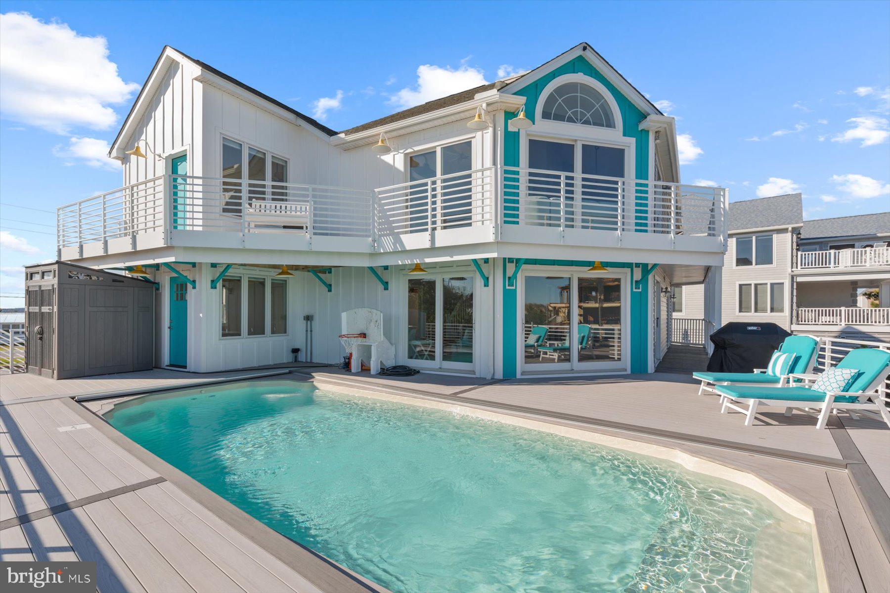Incredible home with ocean views, direct Southern exposure, and a private full-size saltwater pool overlooking the protected state park beach, this prime location is unable to be replicated anywhere on the Delaware Coast.  Just steps to the beach, this home has been thoughtfully designed to take full advantage of unobstructed Ocean views to the South from every level.  The inverted floorplan brings the impressive great room to the upper level with vaulted ceilings and window lined walls that open to an expansive wrap around deck and screened porch.  The crisp white kitchen was recently updated and features stunning quartz counters, stainless steel appliances and timeless shaker cabinetry.  Also on this level is the primary suite with stunning ocean views and an over-sized bathroom with dual vanities, whirlpool tub, and separate shower.  One level below, the elevated first floor offers a large family room with floor to ceiling glass sliding doors that open to the pool deck, creating the ideal layout for friends and family to gather.  Also on this level are 3 spacious bedrooms, 2 full baths, and a wraparound covered porch.  The fully fenced back yard with irrigation can be accessed from the many decks and porches on all levels of this home, making it the ideal layout for your four-legged family members to have easy access inside and out.  Situated at the end of a small enclave of homes in the gated community of Fenwick Acres, this property is just steps to the beach and only a short bike ride to the many quaint shops and restaurants in Fenwick Island.