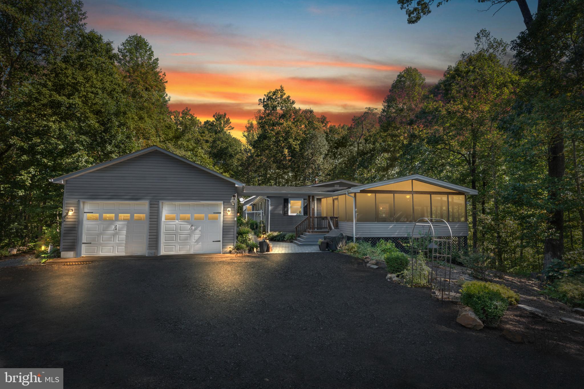 Assumable Financing at 5%!   Discover a captivating blend and distinctive vibe of modern comfort and timeless craftsmanship in this stunning rambler, nestled on a sprawling 6-acre lot surrounded by serene wooded views. Built in 1981, this residence has been meticulously renovated (2019) and is in excellent condition, showcasing the perfect balance of style and functionality. Step inside to find an inviting open floor plan that seamlessly connects the living spaces. The family room, adorned with exposed beams and a cozy corner gas fireplace, creates an ideal setting for relaxation and gatherings. The gourmet kitchen is a chef's dream, featuring upgraded countertops, stainless steel appliances, and a spacious island that invites culinary creativity. A generous pantry ensures ample storage for all your kitchen essentials. The home also boasts formal dining space and a huge sunroom, as well as, a grilling porch. This home offers three well-appointed bedrooms, including a primary suite with a luxurious walk-in closet and an en-suite bathroom featuring an incredible walk-in shower and private screened porch. The additional bedrooms are perfect for guests or a home office, providing flexibility to suit your lifestyle. Enjoy the convenience of main-floor laundry, making daily chores a breeze. Step outside to experience the beauty of nature from your expansive screened in porch, perfect for entertaining or simply soaking in the tranquility of your surroundings. The property also features a screened-in porch, ideal for enjoying warm summer evenings. With additional structures including a second RV garage and a shed, there's plenty of space for hobbies, storage, or even a workshop. The exterior of the home is equally impressive, with durable vinyl siding and an oversized semi-attached garage, along with off-street parking for guests. The lush, wooded lot offers privacy and a peaceful retreat, making it a perfect escape from the hustle and bustle of everyday life, whether it's around the patio or in the beautifully designed gardens. With its unique design, exceptional craftsmanship, and thoughtful features, this home is more than just a place to live; it's a sanctuary where memories are made. Don't miss the opportunity to make this extraordinary property your own and experience the perfect blend of comfort, style, and nature. Schedule your private tour today and envision the lifestyle that awaits you!