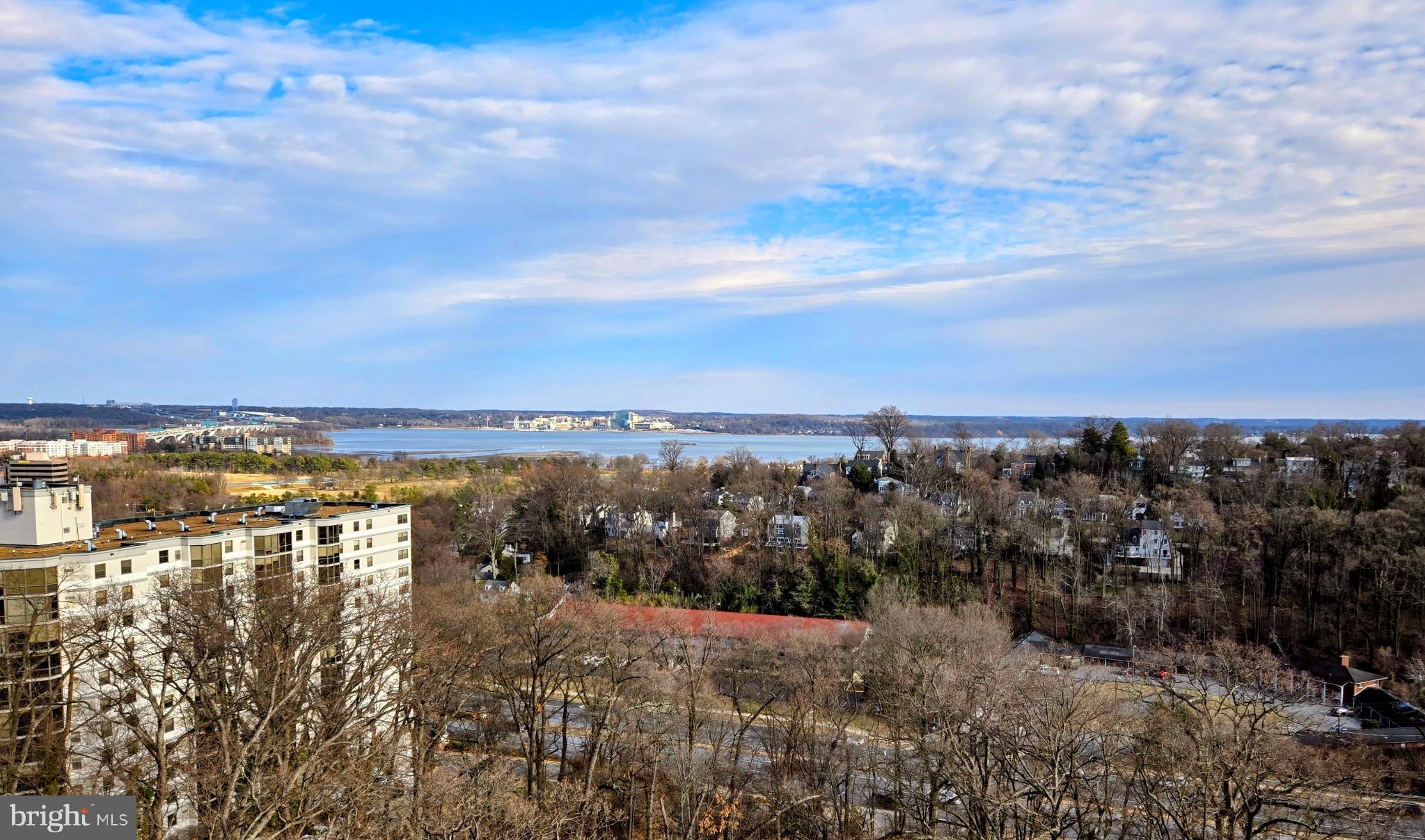 Experience breathtaking sunrises and sweeping views of National Harbor and the Potomac River from this exceptional condo, featuring a spacious enclosed balcony (the largest in Montebello). This private "outdoor" retreat—completely separate from neighboring units—boasts a tiled floor and is accessible from the living room and both bedrooms, with French doors enhancing the connection between the living room and the second bedroom. The sliding glass doors can be opened for a screened-in effect.  Inside,  the open floor plan lends itself to entertaining or cozy nights at home, Gleaming wood floors flow throughout, complemented by elegant crown molding and chair railing. The updated kitchen shines with new appliances, a stylish backsplash, granite countertops, and a convenient eat-in counter. The primary suite offers a beautifully renovated bathroom and custom closet systems for optimal storage.  Additional perks include a reserved garage parking space and a separate storage unit, providing both convenience and functionality. In addition, the storage unit is indoors (by the Hobby Room) so it is climatized! Don't miss this rare opportunity to own a stunning residence with unparalleled views and modern upgrades!  *** ABOUT MONTEBELLO: Montebello is known for its exceptional amenities, vibrant community, and resort-style living. Offering a rich array of cultural, entertainment, and social opportunities, this community provides an unparalleled lifestyle. *** This particular unit boasts a prime location—just steps from the Village Green, a newly upgraded tot lot, a community charging station, and the beautifully renovated community center. Commuting is effortless, with convenient access to the Huntington Metro, North Kings Highway shops, and the post office. Plus, you’re just minutes from Old Town Alexandria, the Beltway, and the Woodrow Wilson Bridge. *** Montebello’s amenities are second to none. Residents enjoy a complimentary weekday shuttle service to the Metro and local shops, as well as access to electric vehicle charging stations. The community features both indoor and outdoor pools, along with a whirlpool and spa for relaxation. For those who love sports and recreation, there are tennis and pickleball courts, a basketball hoop, and even a bowling alley. Outdoor spaces include a dog park and multiple social areas designed for gathering with friends and neighbors​. *** Dining and convenience are also key highlights of Montebello. A full-service restaurant offers both delivery and a ​l​lovely outdoor dining deck. Additional on-site conveniences include a well-stocked convenience store, a fitness center with scenic views, a game room, and an upscale hair salon. Security is a top priority, with 24-hour monitoring and on-site patrolling to ensure peace of mind. *** Montebello sets the gold standard for luxury condominiums—not just for its amenities, but also for its financial stability and exceptional management. The community has never required a special assessment, and fee increases remain below the regional average. Recently, Montebello seamlessly funded an $8 million renovation of the community center, further enhancing its appeal. *** The newly upgraded community center serves as a dynamic hub for social events, concerts, club meetings, and fitness classes. Nestled within 35 acres of serene woodlands, Montebello offers scenic walking trails, grilling areas, and two inviting outdoor patios.  *** The condo building itself features a hobby room, a party room, a book exchange/library, and a heavy-duty washer and dryer for large items. Montebello is also a smoke-free community, ensuring a clean and healthy living environment. *** This is a truly unique oasis in the heart of Northern Virginia, offering something for everyone—whether you’re seeking an active social scene or a peaceful retreat. Come see this exceptional unit for yourself. Contact me today or stop by one of our open houses!