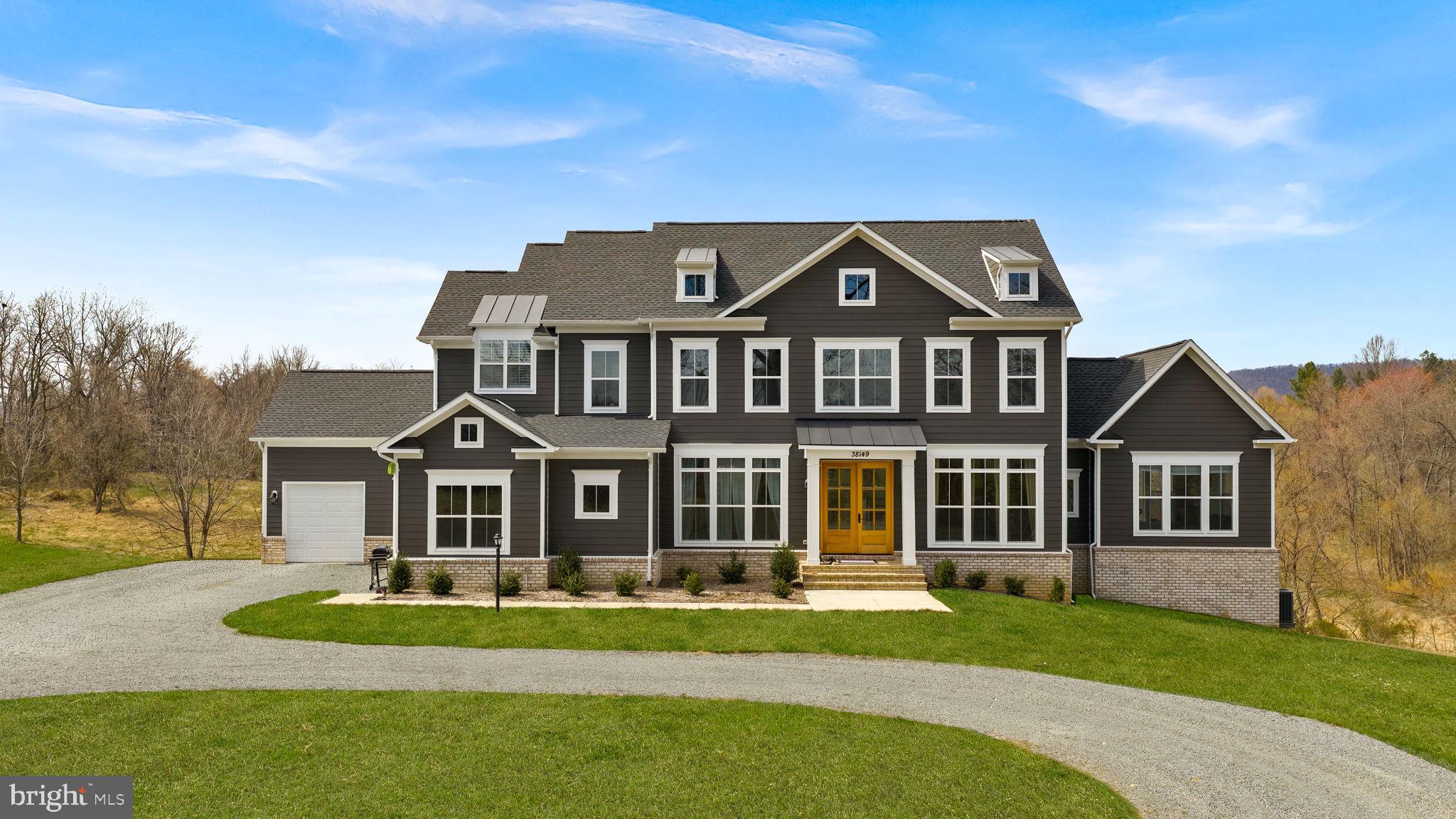 A Rare Estate Opportunity in the Heart of Western Loudoun's Wine Country
Welcome to a one-of-a-kind luxury estate in Hillsboro, VA — where custom craftsmanship meets unmatched privacy on over 17 acres of protected conservancy land. Built in 2023 by Carrington Homes, this semi-custom masterpiece delivers over 8,300 square feet of impeccably finished living space, featuring 5 spacious bedrooms and 5 designer bathrooms.
Tucked at the end of a long, private driveway and framed by rolling pastoral farmland, this estate offers the kind of seclusion and serenity that's nearly impossible to find this close to everything that matters.
Step inside to discover wide-plank upgraded hardwood floors, soaring ceilings, and exquisite architectural trim throughout. The gourmet kitchen serves as the heart of an open-concept floor plan made for effortless entertaining and everyday luxury. Generously proportioned bedrooms and beautifully appointed bathrooms create a sense of comfort and elegance in every corner of the home. Downstairs, a fully finished walkout basement adds even more flexible living and entertaining space.
Outside, enjoy the best of both worlds — manicured lawn space blending seamlessly into expansive rolling, wooded, and pastoral grounds, creating your own private countryside escape. High-speed Verizon FIOS keeps you connected, even in this peaceful retreat.
Minutes from the historic charm of Purcellville & Hillsboro, award-winning local wineries, and scenic country roads, yet still an easy commute to major corridors — this property offers the rare combination of rural tranquility and everyday convenience.
This is more than a home — it's a legacy estate in one of Loudoun County's most coveted locations. Opportunities like this don't come often. Schedule your private tour today.