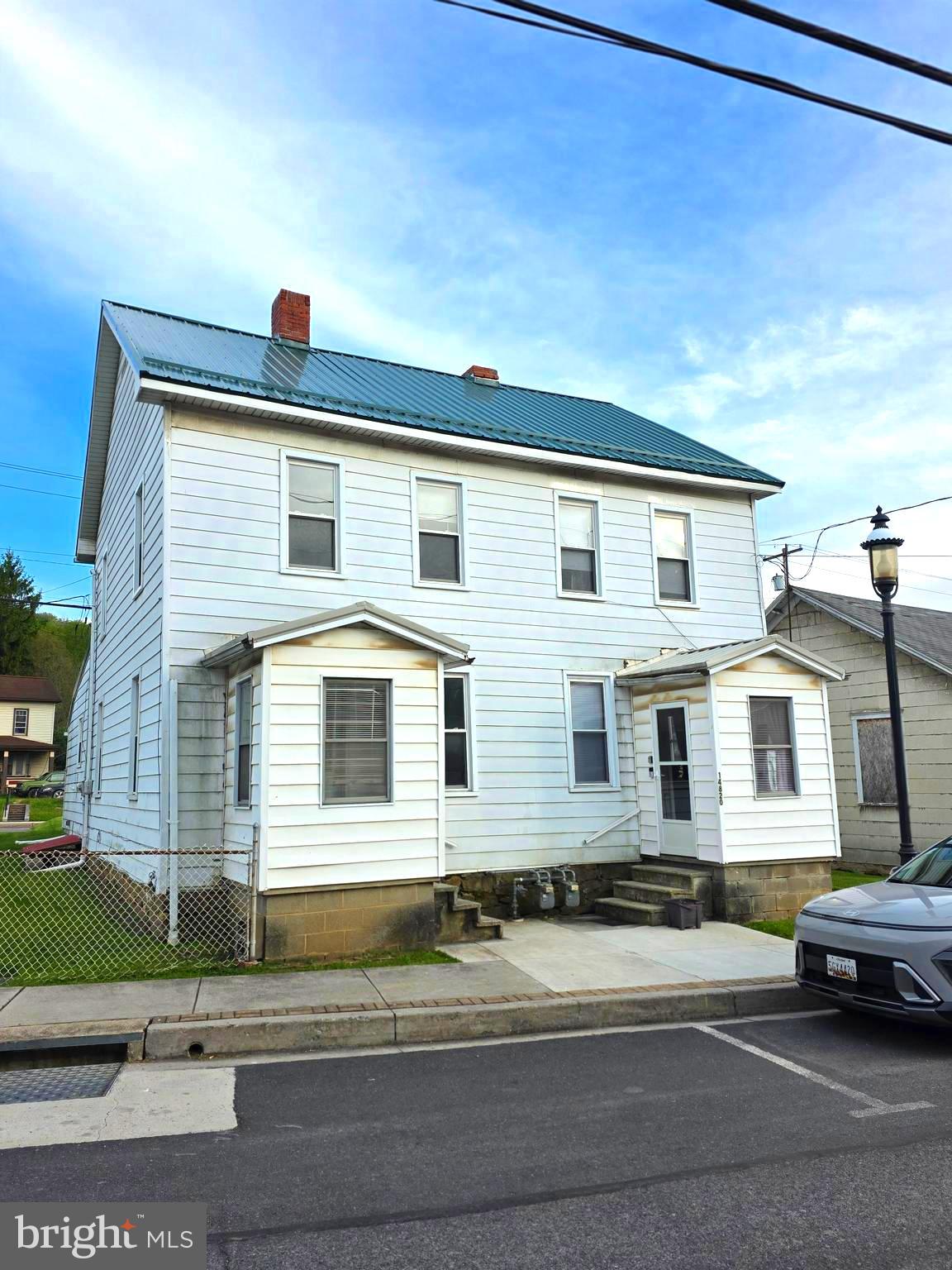 Investment Opportunity with Built-In Income and Room to Grow!  Add this duplex to your investment portfolio and start building income potential from day one. Each unit offers 2 bedrooms and 1 full bath, along with an eat-in kitchen, separate dining room, and large living room — giving tenants the space and  comfort they look for in a rental.  One unit is currently rented for $550 per month to a long-term tenant, with the tenant responsible for her own electric. The second unit is currently being completely remodeled and has a projected rental income of $800 per month, creating an excellent opportunity to increase cash flow once completed.  The owner currently pays water and gas, with water averaging approximately $100 per month and gas averaging approximately $200 per month. Additional features include an enclosed front porch, enclosed rear porch, rear and side yard, and easy access on and off the main road. Conveniently located close to I-68 east and west, food, shopping, restaurants, and everyday amenities, this property offers both convenience and rental appeal.  Whether you are expanding your portfolio or looking for your next income-producing property, this duplex is one to consider. Call today to schedule your private tour! 24 hour notice is required.  Photos coming soon!