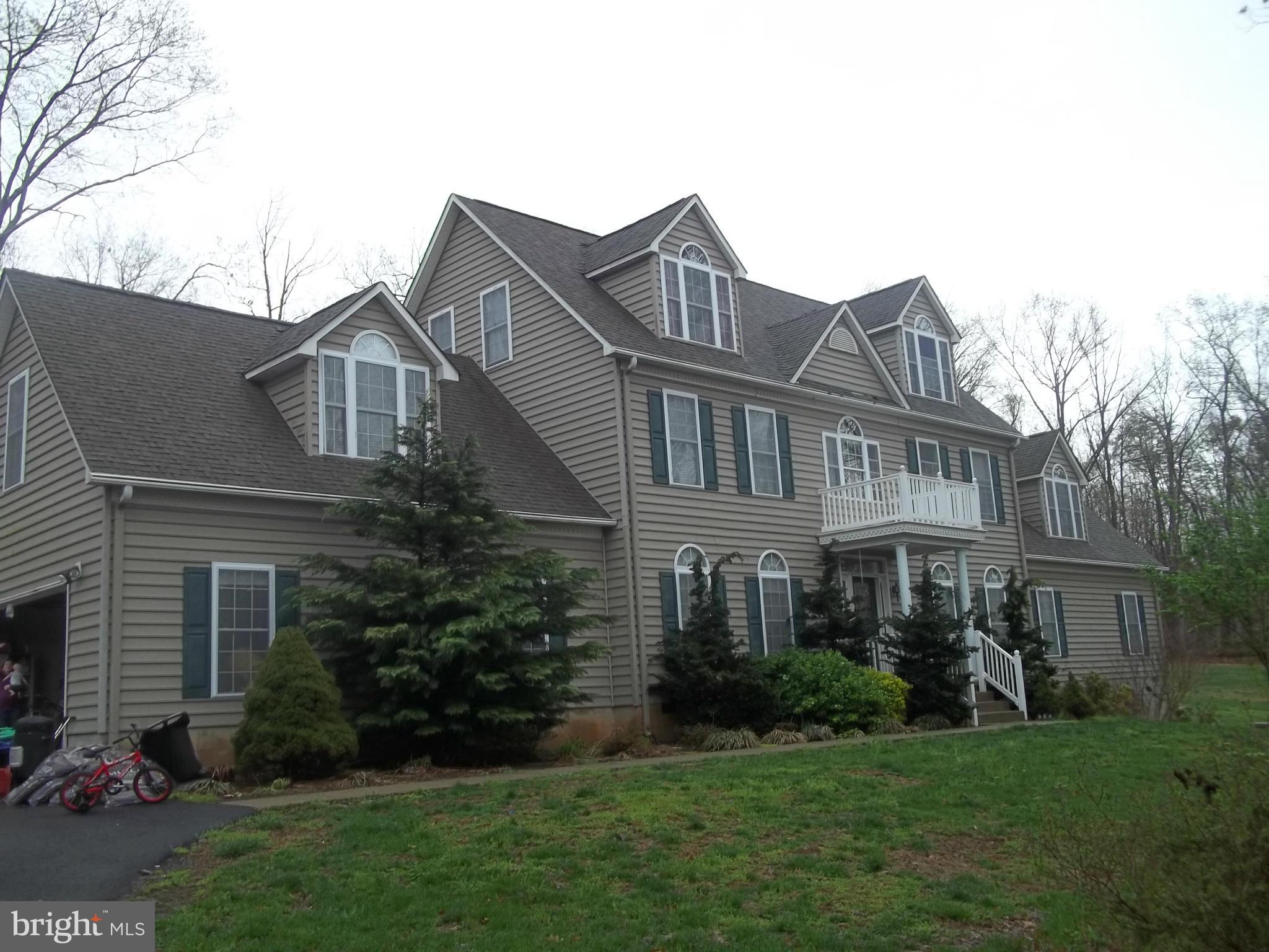 This home is built for 2 families.  It has 2 separate  living areas.  Main level has 3 bedrooms, Den, kitchen, family room, dining room, and 2.5 baths.  Second story has kitchen, family room, 4 bedrooms, 3 baths and living room.  Sits on 11 acres that is very private and wooded.  Over sized 2 car garage with work benches. Close to Rt 229.