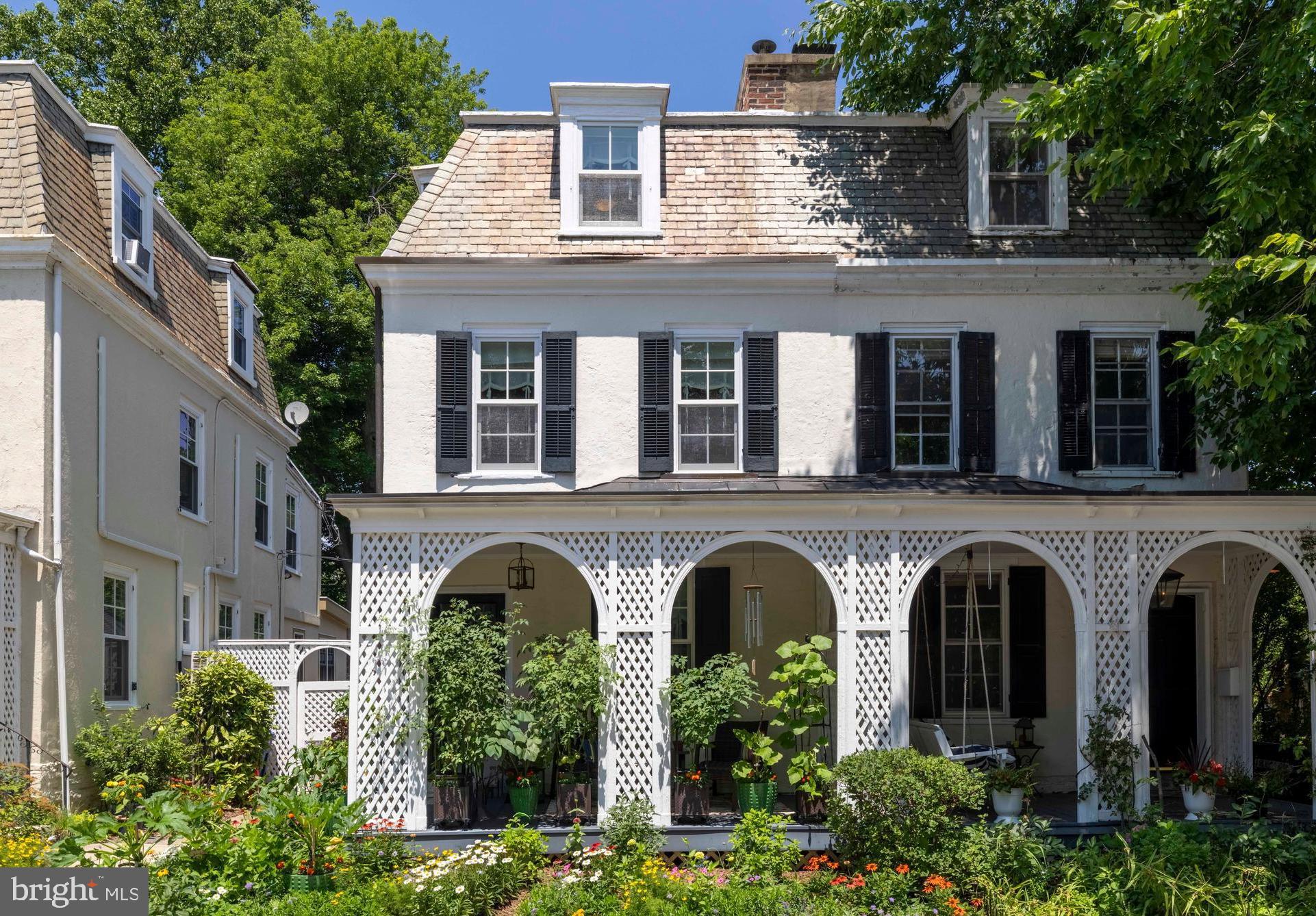 Evergreen Place sits in the heart of Chestnut Hill at the Top of the Hill. Built in 1887 by renowned architect Robert R. McGoodwin, this updated four-bedroom, two-bathroom twin is situated on an intimate cul-de-sac with a distinct neighborhood feel inside one of Philadelphia's most desirable zip codes. A welcoming front porch, bordered by a lovely garden, provides an ideal setting to relax with a good book or enjoy an afternoon drink. Inside, the living room features a gas fireplace, built-in bookshelves, and the hardwood flooring that flows throughout the majority of the home. The formal dining room includes a built-in cupboard, providing an ideal space for hosting guests. The eat-in kitchen features marble countertops, a tile backsplash, newer stainless steel appliances, and a breakfast bar with a scenic view of the grounds. The second floor has two bedrooms, both equipped with ceiling fans, and a full bathroom complete with a marble floor and shower. The primary bedroom includes a built-in closet system, while the second bedroom offers versatility to serve as a sleeping space or a private home office. On the third floor, two additional bedrooms with ceiling fans share a full bathroom featuring a classic clawfoot tub, tile flooring, and traditional wainscoting.  A full basement with French Drain system provides laundry facilities, storage, and a convenient exterior exit with a full set of stairs.  You will love relaxing and entertaining on your covered back patio. The backyard serves as a private oasis, where a brick walkway flanked by beautiful plantings leads to a private flagstone patio. This special home stands out for its exceptional charm and beautifully curated secret garden. The close-knit neighbors on the cul-de-sac share a cooperative arrangement to utilize the parking space directly in front of their respective homes. The current seller has kept meticulous care of the home -recent improvements include roof flashing reinforced and metal roof coated in May 2026, cedar shed and fencing replaced 2023 and a whole list of additional upgrades are available.  The location is a 10 and is just a short walk from the SEPTA regional rail and all the shops and restaurants of coveted Chestnut Hill. HURRY!
