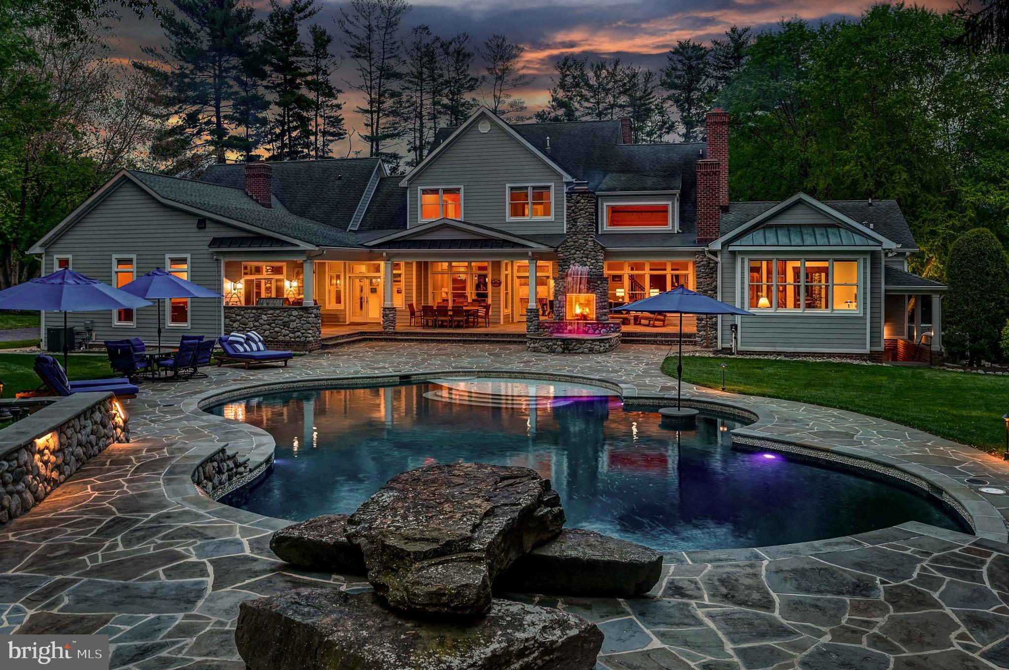 Live Authentically. Revel traversing the secluded lane to your gated oasis. Cross the threshold and come home. The mountain modern aesthetic lives within strong classic architectural lines. The attention to detail is palpable from the moment you open the car door and are caressed by your soothing sound system. Masterful renovations in both 2008 and 2022. Your visions for living are realized. Lush landscaping embraces and soothes from every vantage point. Truly epic outdoor living crafted for ultimate sensory experience... an elemental symphony. Fire, water, wood, glass, stone, and light all come together... a mesmerizing effect. Be inspired to create on your Kalamazoo Hybrid 900 grill. Lounge and dip in your custom sparkling 57,000-gallon self cleaning IntelliChlor Mineral Springs pool. Seamless indoor, outdoor connectivity that resonates throughout. A chef’s cooking space ergonomically designed. Enduring copper and river rock, custom concrete countertops and sinks with Sepele in-lay. Stunning great room with rustic cedar beams anchored by a 16-foot roaring river rock fireplace. Experience the visual poetry of this captivating space. Chestnut floors set the tone for a sumptuous and tranquil owner's suite, where bathing and dressing transform your morning journey. A copper tub that redefines soaking. Radiant heat, walnut vanities, and onyx countertops... texture abounds. The lifestyle experience continues as you immerse into the lower level.  Lose yourself in the state-of-the-art theater with fiber optic sky ceiling. Channel your inner oenophile with 1,000 bottle wine cellar. Enjoy lighthearted endeavors with friends... billiards, game room, and one-of-a-kind hockey/sports room. Incredible location, just minutes from everywhere you want to be. Convenient access while feeling worlds away. See additional documents for more details and seller's amenity list. Cultivate your existence. The art of uniting human and home.