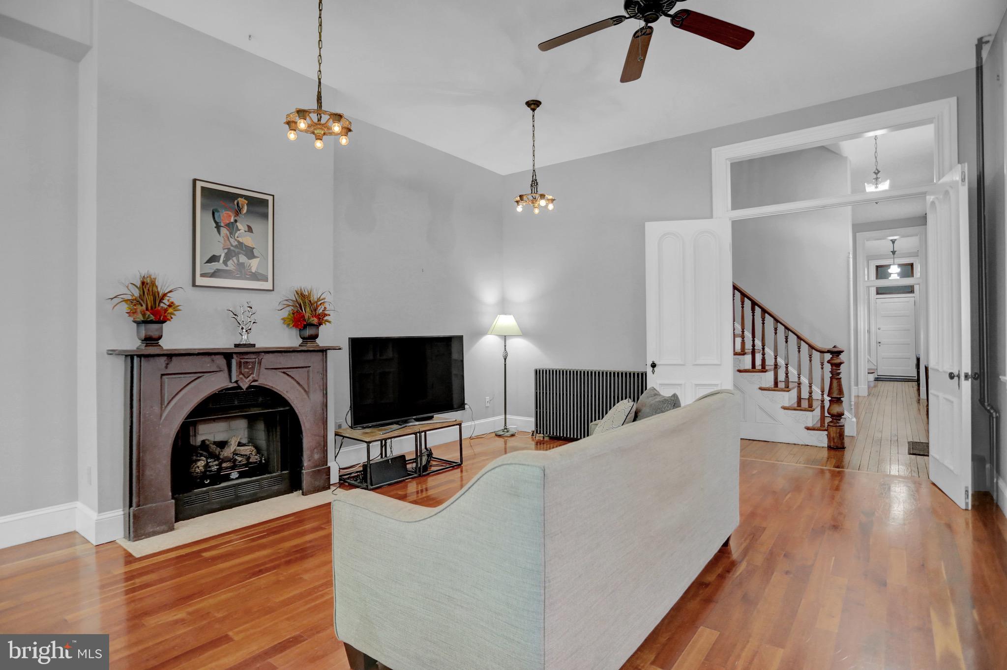 Butchers Hill - GARAGE PARKING.  Grand Victorian with transitional flair!  If you like to entertain, this beautiful home checks the box!  This end of group, 3 bedroom, 3 bath and 2 half bath, updated home, boasts more than 3000 sq. ft of living space above grade with warm hardwood flooring and a partially finished lower level recreation room with an additional 800 sq. ft. that has wonderful built- in seating with storage, new cabinetry, wet bar, granite counters, wine fridge, and a beer tap system and convenient powder room.  
This home offers modern updates that include a gourmet kitchen with upgraded kitchen cabinetry, exposed brick, a gas stove with pot filler, stainless appliances, period lighting, a powder room and high ceiling.   
 The living room is grand with its soaring ceiling, warm hardwoods, gorgeous fireplace mantle, Art Deco light fixtures, dual ceiling fans, and detailed reproduction moulding.  Double doors lead past the main curved staircase into the formal dining room with a curved wall.
The first floor has a back staircase also.  The attached garage is accessed just off the kitchen through a door just beyond the back staircase.  The garage is a side load garage for one vehicle.  
The second level has two private bedrooms with private baths, a laundry and access using front and back staircase.  Primary bedroom has exposed brick, an upgraded marble bath with a skylight, a walk-in shower with dual shower heads and dual sinks.  The second full bath offers a pedestal porcelain sink and a walk in tiled shower. 
 The third floor suite is perfect for entertaining that out of town guest with private bedroom and cool vintage bath that includes a bidet seat.   There are built-ins used as a staging bar with refrigerator just outside the door to an expansive roof deck with city and water views which makes entertaining, easy, pleasant and convenient.   
Prime Butchers Hill location!!  A short walk to Johns Hopkins medical campus, Fell's Point, Harbor East , Baltimore's glorious Patterson Park, and wonderful area restaurants.  Stow your car in your private garage and walk to everything that beautiful Charm City has to offer!