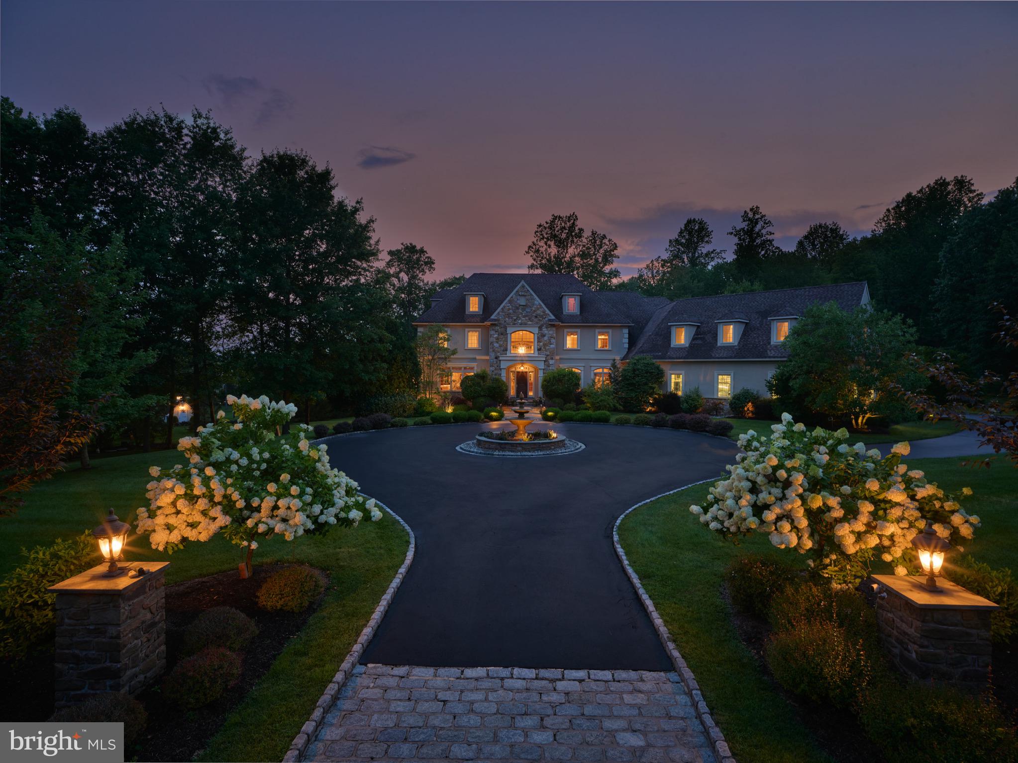 MULTI-GENERATIONAL LIVING • TWO PRIVATE GUEST/NANNY/IN-LAW SUITE OPPORTUNITIES • 4.25 ACRES • AWARD-WINNING NEW HOPE-SOLEBURY SCHOOLS• HEATED 4-CAR GARAGE

Experience exceptional luxury on 4+ acres in one of Solebury Township's most coveted enclaves. Ideally positioned on a quiet cul-de-sac, this custom-built Bucks County estate offers a rare combination of acreage, privacy, and architectural presence—introduced by a stately circular drive and fountain that set the tone for what lies beyond.

Step into the marble foyer featuring a stunning curved staircase and exquisite custom millwork. Designed for both everyday living and sophisticated entertaining, the chef's kitchen offers radiant heated floors, professional-grade stainless Wolf gas range, two paneled dishwashers, paneled Sub-Zero refrigerator and two refrigerated drawers, expansive granite surfaces, and an oversized center island. The dramatic 20+ foot coffered family room is anchored by a  stone fireplace and framed by walls of windows overlooking the expansive lawn and picturesque treed meadow beyond. A formal sitting room with gas fireplace, elegant dining room, butler's pantry with wet bar, and a private office with custom built-ins and access to the wrap-around covered porch complete the main level.

Upstairs, the luxurious primary suite offers a true retreat with a separate sitting area, two walk-in closets, tray ceiling, and a separate flex room ideal as a custom dressing room, fitness studio, second private office, or second-floor laundry. The spa-inspired bath features a steam shower, jetted soaking tub, dual vanities, and radiant heated floors. Three additional ensuite bedrooms complete the second floor.  A private third-floor suite with its own full bath—perfect for a nanny, au pair, in-laws, adult children, long-term guests, or multigenerational living.

The finished walkout lower level is thoughtfully designed for entertaining, featuring a custom bar with fridge, sink, and clear ice machine, a gaming area, and dedicated home theater with projection and surround sound. A second private bonus room adjacent to a full bath provides another exceptional opportunity for guest accommodations, an in-law or nanny suite, multi-generational living, a fitness room, or a private home office. A large unfinished workshop offers abundant storage/hobby space and stairs leading up to the garage.  A wall of windows and French doors create a seamless connection to the covered patio and backyard.

Outdoors, the 4.25-acre setting offers endless possibilities, with ample room for a future pool, pool house, and outdoor kitchen, complemented by patios and a wrap-around covered porch. Additional amenities include a whole-house generator, security system, and a heated 4+ car garage featuring premium SwissTrax flooring, extensive cabinetry and shelving, and interior stairs leading directly to the lower level. It is equipped with central vaccuum and de-ionizer for washing your car.

Located within the award-winning New Hope–Solebury School District and just minutes from the vibrant river towns of New Hope and Lambertville—with convenient access to New York City, Princeton, Nj area, , and Philadelphia—this remarkable estate presents a rare opportunity to own a private property of exceptional scale, flexibility, and enduring quality in the heart of Bucks County.