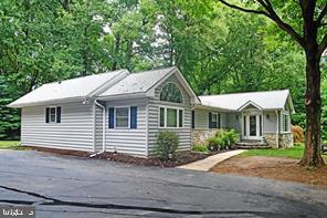 Nestled in a serene and private setting within the highly acclaimed Unionville-Chadds Ford School District, this exceptional home offers approximately 3,900 sq. ft. of living space on a picturesque 3.1-acre lot. The half-wooded property features a tranquil 1/3-acre pond stocked with koi, bass, and minnows, along with a gentle stream—creating a peaceful natural retreat right in your backyard. The multi-level deck with a charming gazebo is perfect for entertaining or relaxing, and the walk-out patio leads to a heated swim spa/jacuzzi. Step inside to a bright, airy custom sunroom addition, ideal for soaking in natural light in any season. The living room features a large picture window overlooking the grounds, and the formal dining room offers French doors that open to the deck for seamless indoor-outdoor living. The kitchen has been recently updated with vinyl plank flooring and new granite countertops. The spacious primary en-suite includes a jetted soaking tub, a large multi-spray shower, a generous 7’ x 9.5’ walk-in closet, and a cozy sitting room. A second bedroom, home office (or third bedroom), hall bath, and ample closet space complete the main level, with an optional main-floor laundry hookup. The 75% finished walk-out basement adds versatile living space with a large family/rec room, two bedrooms, a half bath with a new vanity, a wood-burning fireplace, and a dedicated laundry room—plus direct access to the swim spa/jacuzzi. Additional highlights include a detached two-car garage with a workshop and heated storage, a carport for extra covered parking, and a full-property invisible dog fence for pet safety. This one-of-a-kind home offers the perfect blend of space, comfort, and natural beauty—a true private oasis. Don’t miss your chance to make it yours. Professional Photos to come.