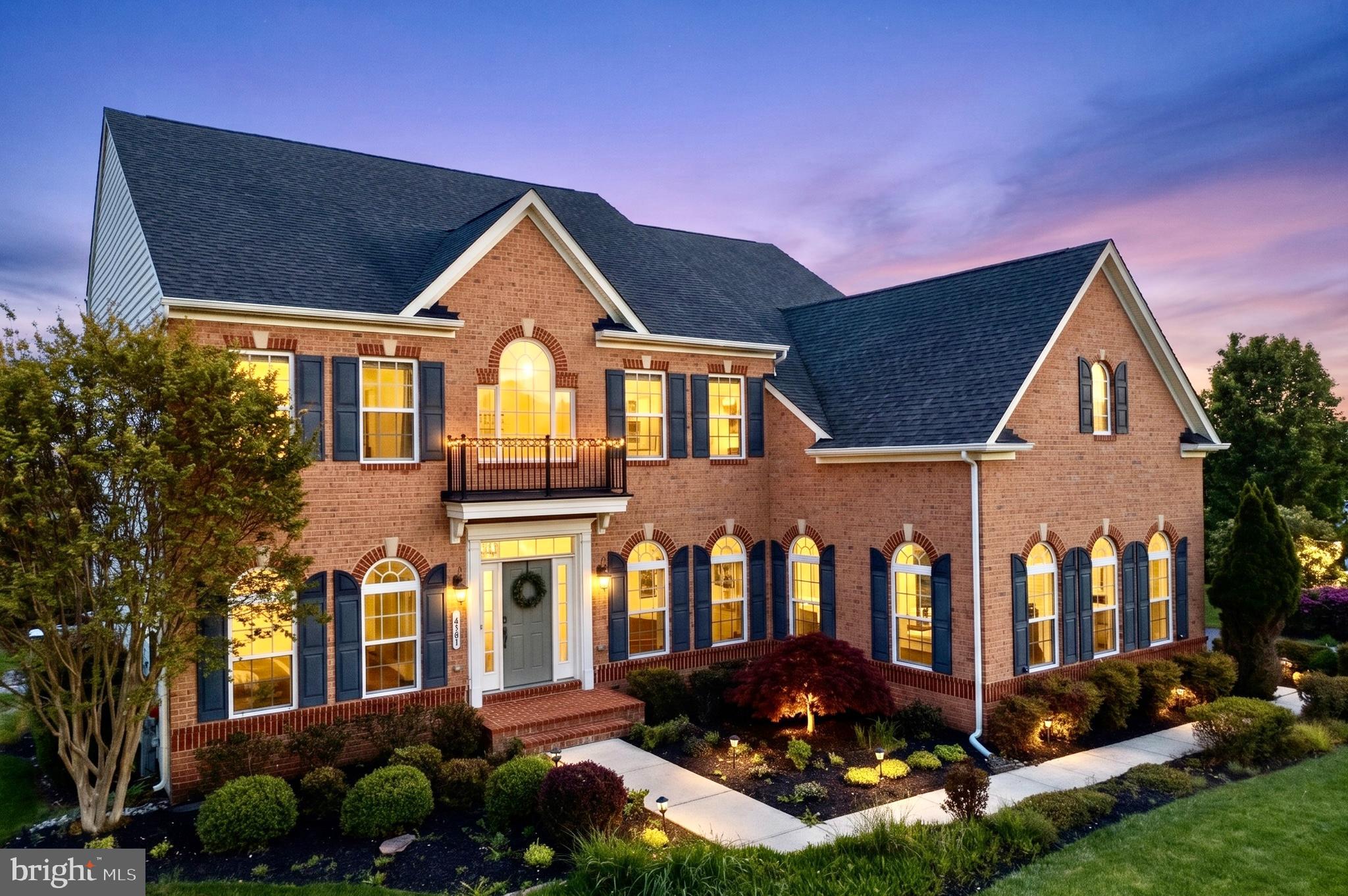 Welcome to 14581 Triadelphia Road, an exquisite Glenelg estate that exemplifies luxury and meticulous attention to detail. Sparing no expense, the owners have impeccably maintained this stunning NV Homes property to create an extraordinary living experience. Situated in one of Western Howard County’s most sought-after communities, this residence boasts over 6,700 square feet of elegant living space, featuring five bedrooms, four and a half spa-like bathrooms, and an oversized three-car garage. Upon entering, you are greeted by a grand two-story foyer adorned with exquisite marble tile and stunning Palladian windows. Gleaming high-end luxury vinyl plank flooring and elegant crown molding flow seamlessly throughout most of the main level. Flanking the foyer are a formal living room and a sophisticated dining room, complete with a tray ceiling and abundant natural light streaming through arch-top windows. The culinary masterpiece of a kitchen is a true chef’s delight, showcasing custom cabinetry, a large center island with custom granite countertops, under-cabinet lighting, and a butler’s pantry. Outfitted with updated stainless steel appliances (2024), a five-burner gas cooktop, a pot filler, and a breakfast bar, this kitchen offers unparalleled functionality. The open floor plan transitions effortlessly into a sunroom-inspired breakfast nook and a breathtaking two-story family room. Here, dramatic Palladian windows and a gas fireplace, anchored by custom built-in cabinetry, create a warm and inviting ambiance for both intimate gatherings and larger events. The main level is completed by a sun-drenched office enclosed by elegant French doors, a perfectly positioned half bathroom, and a convenient mudroom/laundry room featuring granite counters and a sink. Upstairs, the primary bedroom suite serves as a private oasis. This luxurious retreat boasts two spacious walk-in closets, a serene sitting area, and a personal balcony perfect for enjoying morning coffee or unwinding after a long day. The en-suite spa bathroom features a deep soaking tub, a walk-in shower, and dual vanities. The upper level also includes a generous second bedroom with its own private en-suite bath, while two additional spacious bedrooms share a well-appointed hall bathroom. The recently renovated lower level (2021) offers an impressive 2,213 square feet of expansive, versatile living space with tall ceilings. This vibrant entertainer's dream features a second home office/playroom with French doors, a dedicated workout room or a fifth bedroom, and a media/theater room. A newly renovated full bathroom, a stunning built-in bar equipped with a dishwasher and refrigerator/freezer, a dedicated wine room, and two spacious storage areas ensure this level adapts effortlessly to your lifestyle. Step outside to a gorgeous outdoor sanctuary featuring a sprawling paver patio and connecting walkways. A beautiful screened-in porch, added in 2021 and accessible from the kitchen, offers tranquil views of the lush backyard. Practicality meets luxury with an extra-wide driveway extension, an oversized three-car garage with built-in storage, and the rare advantage of a fully owned 500-gallon propane tank. Truly move-in ready, the home offers incredible peace of mind with major recently upgraded systems, including a lower-level HVAC (2025), upper-level HVAC (2022), hot water heater (2025), washer and dryer (2024), and a freshly serviced irrigation system (2025). Discover the perfect place to call home, where comfort, style, and luxury are evident in every single detail.