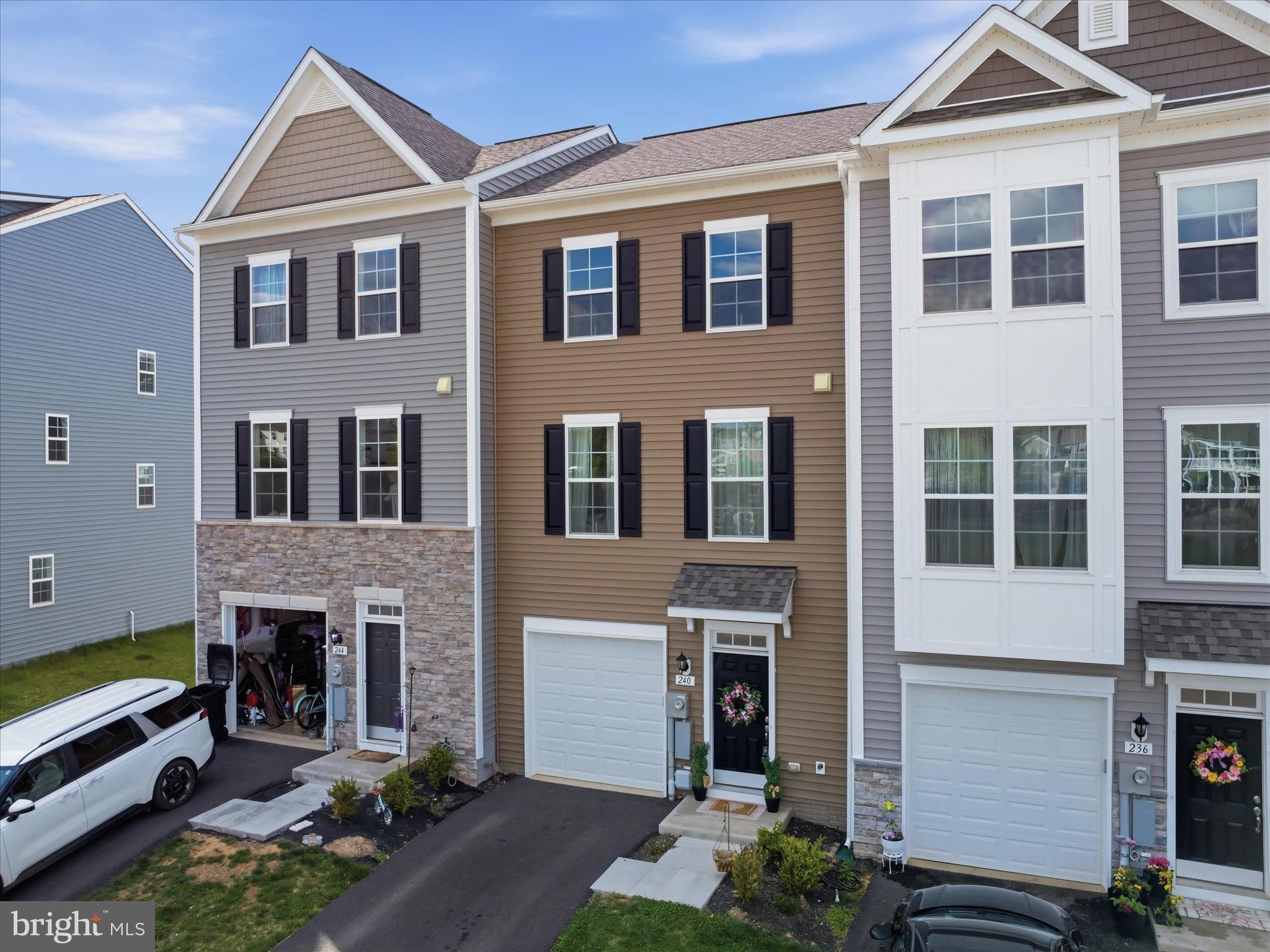 Why wait to Build - when this home is practically new. Beautiful Townhome in the sought after community of The Martinsburg Station. This community offers Pool, Clubhouse, Walking Trails, Pickle Ball/Tennis courts, Basketball Court, and Playground. This home is 3 Bedrooms, 3.5 Baths and incredible well taken of. The foyer includes a double coat closet that leads into a finished rec room with a full Bath. Foyer with boxed oak staircase that leads to an open concept main level. The kitchen comes with complete stainless steal appliances, Upgraded cabinets, over sized island, quartz countertops, and powder room. Another boxed oak staircase that leads to a primary suite, large walk-in closet, bathroom with dual vanity, and oversized shower with seat. Laundry is also located on the bedroom level. Additional 2 bedrooms and a full bath. This home has a 1 car garage.