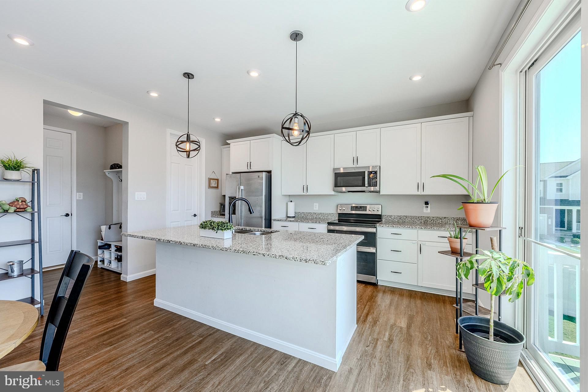 Seller is offering a $5000 credit to Buyer. Welcome to this beautifully maintained 3-bedroom, 2.5-bath single-family home in one of Strasburg’s newer and sought-after subdivisions. Set on a desirable corner lot with one of the largest yards in the neighborhood, this home offers 2,235 square feet of thoughtfully designed living space, a 2-car garage, modern finishes, and peaceful mountain views. ****** A charming front porch welcomes you as you step into the main level featuring an open-concept layout with warm luxury vinyl plank flooring that flows throughout the living room, kitchen, dining, and family room areas. The kitchen offers an abundance of 42” white shaker style cabinetry, gleaming granite countertops, a walk-in pantry, and stainless-steel appliances. A large center island with chic pendant lighting provides bar seating and easy flow into the dining area and spacious family room, where a sleek modern electric fireplace with blower creates a warm and inviting focal point. Large triple sliding doors open to the deck, where you can relax and take in the beautiful mountain views and quiet neighborhood setting. A powder room and mudroom area with direct garage access rounds out the main level. ****** Upstairs, you’ll find a versatile loft area that is perfect for a sitting/study/play area. The spacious primary suite boasts walls of windows, plush carpet, a lighted ceiling fan, and huge walk-in closet. The luxurious ensuite bath features a granite topped dual sink vanity, an additional vanity area, water closet, and an oversized glass enclosed shower. Two additional bedrooms, each with lighted ceiling fans, share access to the hall bath with a granite topped dual sink vanity and tub/shower combo. A large laundry room with utility sink adds convenience.  The expansive unfinished walk-out lower level with full bath rough-in provides loads of storage space and excellent potential for room to expand with your own personal design! ****** Outdoor living is a true highlight, with an extended PVC/vinyl fenced yard, enlarging the outdoor space, and newly planted Leland cypress and additional trees designed to enhance future privacy. Additional features include Bluetooth surround sound, a Wi-Fi extender, modern finishes, and convenient access to shopping, major routes, and I-66 for commuters. This home combines comfort, functionality, and scenic surroundings in a peaceful Strasburg setting.