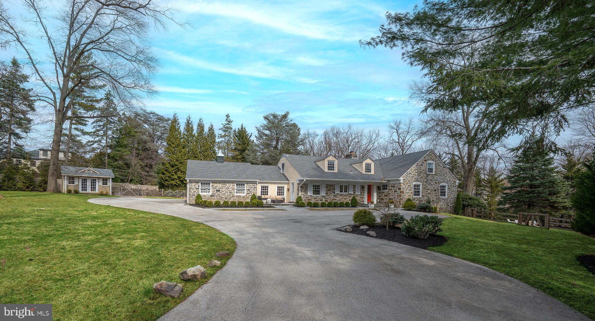 Welcome to this fabulous, renovated, 4000+ sq ft home located in the heart of Bryn Mawr. Offering 5 spacious bedrooms, 4 full bathrooms, and 2 half bathrooms, this home is the perfect blend of luxury and comfort. Situated on a beautiful interior and private lot, the property features a fabulous heated inground swimming pool, a fire pit, and a gazebo with a built-in BBQ and kitchen, creating your oasis for outdoor entertaining and relaxation.  Step inside to find a thoughtfully updated, beautiful kitchen, which is complete with white wood cabinetry, quartz countertops and breakfast bar, stainless steel appliances, a spacious island with seating, and a sizeable convenient pantry. The open concept floorplan flows seamlessly into the bright dining area, and living room with chair-rail, crown molding, and a wood-burning fireplace, creating a welcoming atmosphere perfect for elegant and casual get-togethers.  Sliders lead out to the tranquil paver patio, and gorgeous grounds ideal for indoor-outdoor living.   Step down to the cozy family room just off the kitchen.  The luxurious 1st-floor primary bedroom suite is a true retreat, featuring two custom, walk-in closets and a vast, updated ensuite bathroom with a double vanity, soaking tub, and shower. A versatile bedroom/office with another full ensuite bathroom, a bonus space and access to private deck makes the perfect in-law suite.  A half bathroom completes the main floor.  Upstairs, a private bedroom suite with a walk-in closet and complete bathroom offers added comfort and privacy, while two additional bedrooms share a beautiful full Jack and Jill bathroom. The finished lower level boasts a huge recreation room, half bathroom, laundry room, and plenty of storage, with an outside entrance for convenience. Additional features include a whole-house generator, new gutters, new roof, new windows, and new HVAC, ensuring comfort and peace of mind. A 2-car garage adds to the home's practicality.  Located in a desirable neighborhood within the award-winning Lower Merion School District, this exceptional Bryn Mawr home offers everything you need — a true sanctuary for everyday living and entertaining.