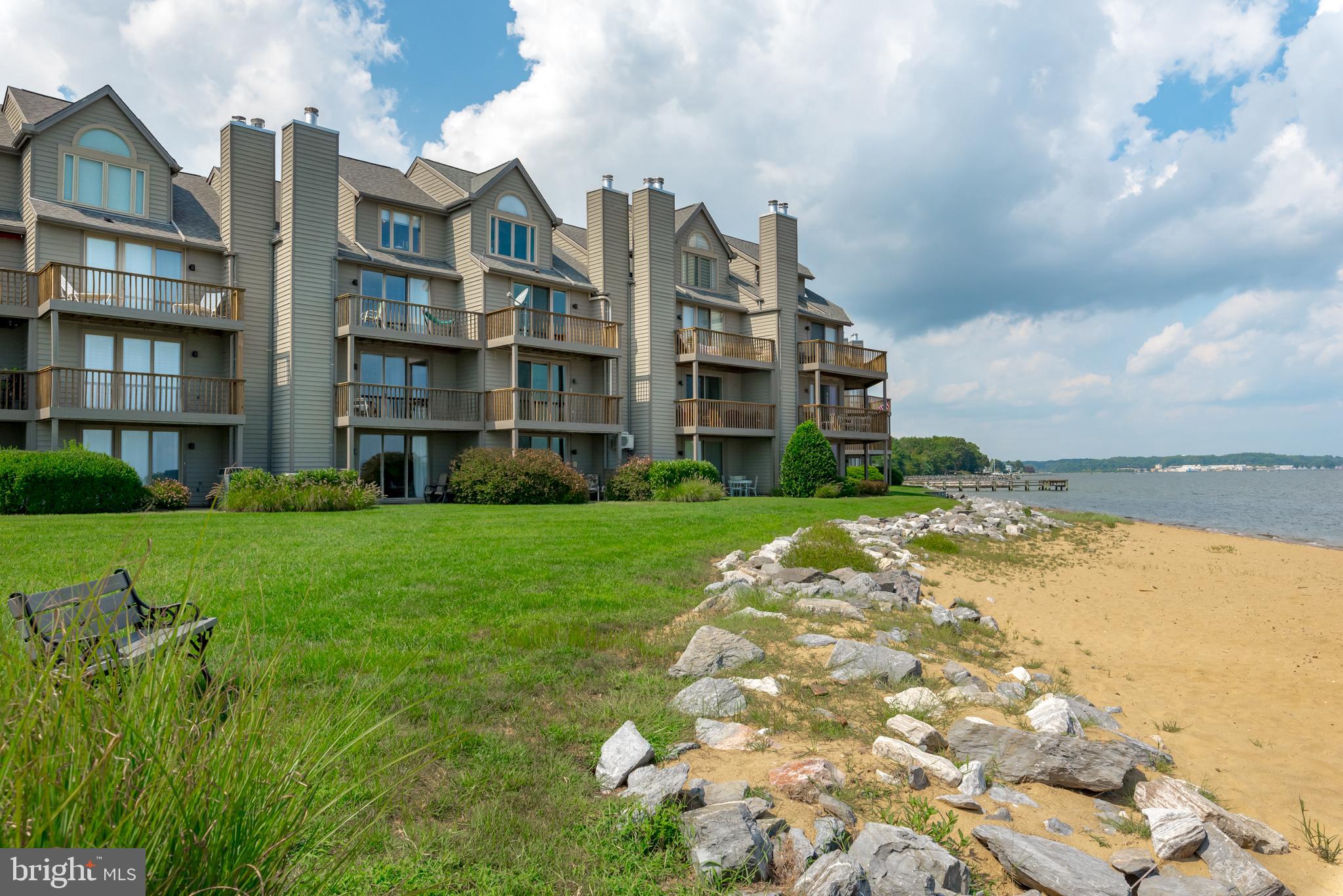 Luxurious Townhome offering  expansive water views of the Chesapeake Bay and Bay Bridge. Wake up to the sounds of waves and views of the beach below!  Home features 4 levels of breathtaking views with an elevator for easy access to all levels.  Updated all-white eat in gourmet kitchen. Remodeled large Primary Suite with waterfront deck, dual walk-in showers and double vanities. All the bedrooms have been updated to include custom cabinetry, solid wood doors and crown molding. All hardwood floors and recent exterior sliders. One car garage and workshop . Walk out the lower level opens to the fabulous community beach. The gated community offers amenities that makes you feel as if you are on vacation all year round.  Two pools, four tennis courts, jogging and walking paths, piers, kayak launch, marina, beaches as well as Sam's Waterfront restaurant with its very own tiki bar. Minutes to Downtown Annapolis and a short boat ride down ego alley. Easy commute into Baltimore and Washington, DC.
