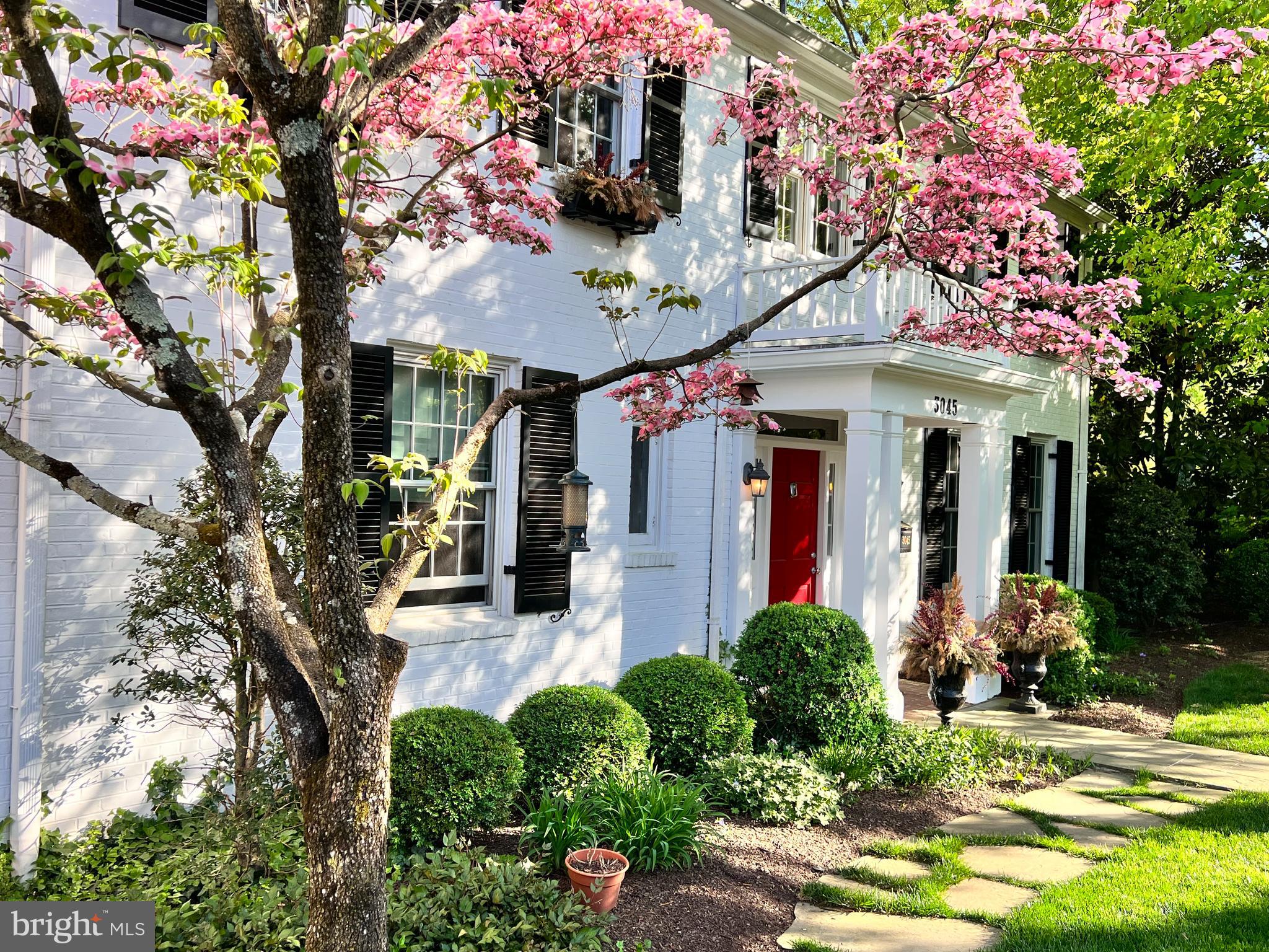 Spectacular property, nestled on a ⅓ acre lot and proximate to larger estates,  3045 Chain Bridge Road NW is a  park-side jewel of a home, and presents an exceptional opportunity for refined, private,  unpretentious living.  The house has everything:  6 bedrooms, 5 baths, a home office, a home theater,  recreation room,  custom wine cellar, two car garage, indoor outdoor living spaces all next to a glorious garden with fabulous lush views from every window.  It is very rare to have this much garden, accessible to a glorious public park. You have your own personal oasis right in the city.  The property is fully fenced, and has its own gated access to Battery Kemble Park (which is famous for its sledding and dog park.) 
Boasting excellent flow for entertaining, the main level offers gracious living areas with lots of place to sit, enjoy the view.  The living room, library, and solarium are three  connected overlooking the garden through a huge plate glass window.  Those rooms seamlessly connect to the dining room, and a beautiful deck, creating a perfect space for gatherings and outdoor dining. The gourmet kitchen is complete with top-of-the-line appliances and a custom designed  breakfast nook.  It is beautifully designed with built in table at one end and TV hang out sitting room on the other.  
The primary suite is a sanctuary of luxury, boasting a spa-like ensuite bathroom, a private deck,  his and hers closet space. The additional bedrooms are generously sized three total on the second floor (with home office) and two more on third floor. This layout  offers versatility for guests, home offices, or personal hobbies.
The long driveway offers quick off street parking, and goes down to a play space and entry to the attached  2-car garage.  There is plenty of room for bikes, kids games, and a spot for catering if a big party is hosted. 
Then there is the magnificent garden that boasts signature plants, mature trees, a stone patio on multiple levels.  It is so gracious, beautifully thought out, and feels like you are in the country. Many happy parties have taken place in this garden space. 
Chain Bridge Road is one of the oldest streets in the city, with long history pre-Civil War at the top of the city next to Battery Kemble.   It is very convenient to Wesley Heights and Spring Valley shopping,  is walkable to the Palisades  library, restaurants and shops along MacArthur Blvd.  This location is 15 minutes from Reagan Airport and 25 minutes to Dulles International Airport.  
Experience the epitome of refined living in this meticulously crafted home, where every detail has been thoughtfully considered. This gracious sanctuary awaits.