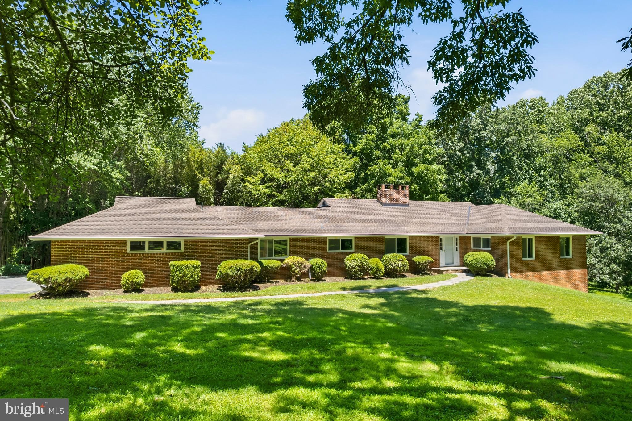 Discover this charming brick ranch-style residence nestled on a plush 3.22-acre lot in the desirable Aintree Estates community within footsteps of Brighton Dam reservoire. This well-maintained home features three spacious bedrooms, two-and-a-half ceramic baths, hardwood flooring, and an inviting open floor plan. The updated gourmet kitchen is equipped with stainless steel appliances, granite countertops, Brazilian cherry hardwood flooring, cherry cabinets, an island, desk area, under cabinet lighting, plentiful recessed lighting, and a breakfast bar, making it ideal for both casual dining and entertaining. Enjoy the bright living room complete with a brick wood burning fireplace and hearth. The den provides access to the large deck with built-in seating, the screened gazebo, as well as the back yard. The serene property backs-up to parkland and trees, with scenic vistas and a peaceful ambiance, perfect for those seeking a blend of indoor elegance and outdoor tranquility. The primary suite features four walk-in closets and a ceramic bathroom with a walk-in shower. Two additional bedrooms and a full ceramic bathroom complete the bedroom wing of the home. Tons of potential in the huge unfinished walk-out basement with 9' ceilings, brick wood burning fireplace and hearth, rough-in for third full bath and two additional bedrooms. The property also offers an attic fan for added comfort and a spacious attached side load two-car garage with additional storage and a paved driveway for convenient parking. Served by private whole-house generator, well & septic. Easy access to great schools, four Columbia Lake parks, including lake activities, tennis courts, sports fields, and miles of paved walking/running/biking paths, dining, shopping & entertainment. Convenient location to Clarksville, Ellicott City & Olney, downtown DC, Baltimore, Annapolis & Frederick, and in close proximity to BWI, NSA, NASA, MARC rail and major transportation routes. Experience the best of suburban living with a private retreat feel, while being just moments away from local amenities. Open Houses scheduled for 6/27 and 6/28 from 1-3 PM. Call Marty with any questions.