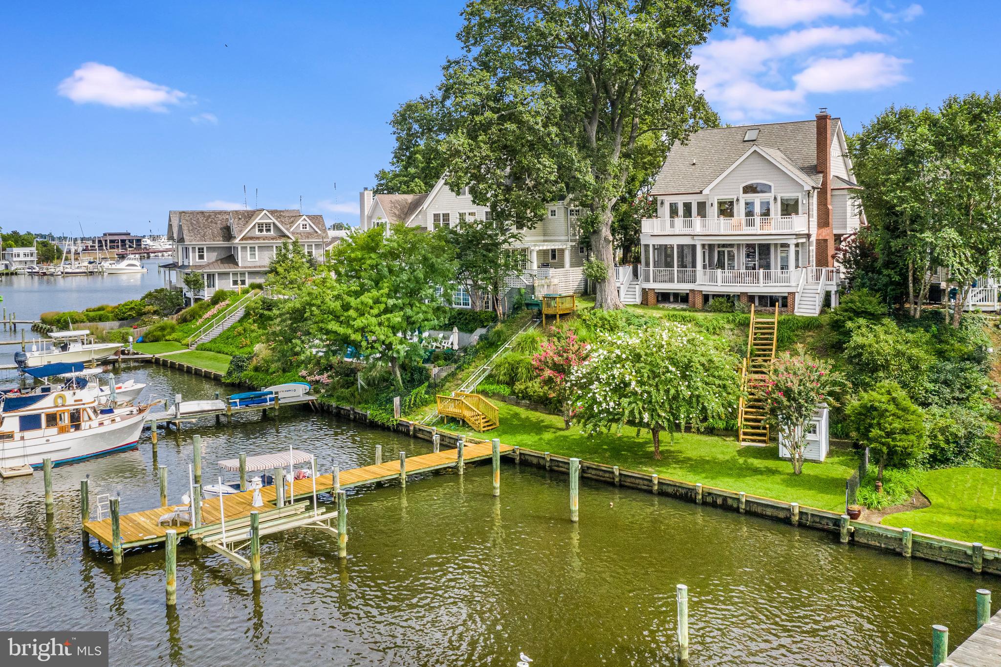 From sunrise to sunset...inspiring water views, majestic herons, bells of St. Mary's and a panorama of historic domes across your horizon.  This elegant waterfront home is the perfect blend of comfortable Southern charm and vibrant coastal living.  Tucked away in a quiet enclave of homes on one of Eastport's most coveted streets on picturesque Spa Creek - the world is your oyster!   With views from nearly every room, several open decks, and a delightful screen porch, this property offers outdoor entertaining space and an unparalleled waterfront lifestyle.  In this quintessential Annapolis home, you can watch graceful sailboats quietly gliding by on a summer night, water taxis coming and going, standup paddle boarders, and small powerboats puttering down the creek. Step from your classic Southern front porch into a grand foyer that opens up to a glistening waterfront setting.  Space, grandeur and light beckon into the elegant but comfortable rooms with warm hardwood floors and tasteful design.  A cozy study offer a wood-burning fireplace and custom built-in shelves.  The open kitchen, dining and living areas, focus on the waterfront setting that will change with each season.  Light a fire in the living room and watch the quiet creek in the winter or open the doors and delight in the summer breezes and sunsets.  The kitchen is outfitted with classic granite counters and the perfect eat-in bar for great entertaining floor.  A main floor bedroom and full bathroom give you flexibility for guests or a back-up bedroom when steps are not an option! Wake up to morning water views from your spacious master bedroom suite.  French doors open to a wrap-around balcony for morning coffee for an evening libation.   The master bath suite features marble floor and vanities, walk-in closet, soaking tub with separate shower, and a coffee station/wet bar.  A small room that adjoins the master bedroom can be used as an extra guest room, office, or sitting room.  The second floor also features a guest bedroom with adjoining boutique bath/shower and a laundry room.   Distinctive highlights and upgrades to this house include custom crown moulding, custom fireplace mantels, newly refaced kitchen cabinets, Casablanca ceiling fans, refinished hardwood floors, copper gutter and downspouts and a superior sound system with speakers on the outside decks and most rooms.  The property has two deep water boatslips, a boatlift and 83 feet of waterfrontage that is protected with recently improved bulkheading.  There is a tram to carry people and boating gear from the backyard down to the waterfront, new stairs, and a boat shed for boating supplies and garden tools near the dock.  Out your door and down the steps - and you can be crabbing, fishing, kayaking, paddle boarding, sailing or powerboating or heading out by boat to restaurants or visiting friends by boat on the creek. With a premium location in Eastport and a home that is perfectly designed for waterfront living, relaxing and entertaining - this home has it all.  Close proximity to local restaurants, maritime museum, yacht clubs, and downtown Annapolis.  Seasonal water taxi pickup at your dock for drop off at City Dock and waterside restaurants. This is urban living on a quiet street with a fabulous waterfront scene that will delight from morning to night.  This house offers a front row seat with an historic backdrop in one of America's top, small waterfront cities.