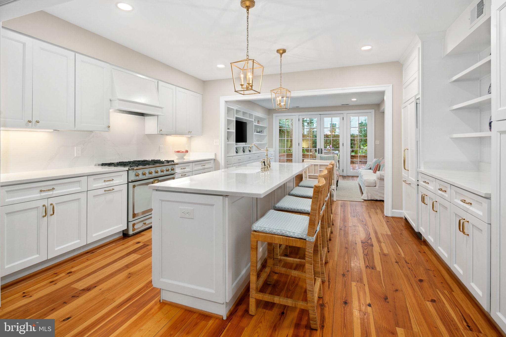 Incredibly rare opportunity for an incomparable home situated on one of Old Town's most picturesque and sought after blocks. This custom home features a stunning addition completed in 2020 to intentionally preserve the character of 1880, when the home was originally built, while seamlessly tripling the home's size with today's conveniences. The addition was thoughtfully designed and constructed by one of Old Town's premier local builders and preservationists, Bill Cromley. Unique floor plan featuring 4 bedrooms and 3 full baths on upper level including two ensuite bedrooms. Bright and open main level ideal for those looking for fewer levels and stairs than the typical Old Town home. From the front entrance you are welcomed by the living room with original fireplace and built-ins. Once through the living room the addition offers open living between dining, kitchen and family room with wall of glass and French doors overlooking 15ft x 15ft brick patio and sizable back yard. Two separate entries add to the convenience including gated side alley with covered entry door and only one step inside! The home also features: 2 wood burning fireplaces, wide plank heart pine flooring throughout, original trim detail, custom elegant white Kitchen with statement "Tapestry Blue" La Cornue gas range as its centerpiece, custom built ins including mudroom "locker area" off side entry, custom lighting, primary suite with walk in closet, double vanity and beautiful curbless marble shower. Secondary suite has 2 large closets, original fireplace, built ins/desk area, and private full bath. Hall bath has period correct claw foot tub, beadboard trim, and marble floor. Dual zone HVAC(both units 2019). Incredibly convenient to everything Old Town has to offer! Down the street from Windmill Hill Park, Jones Point Park, GW Parkway path, King St, 5 miles to DCA airport, and only 7 miles to DC.