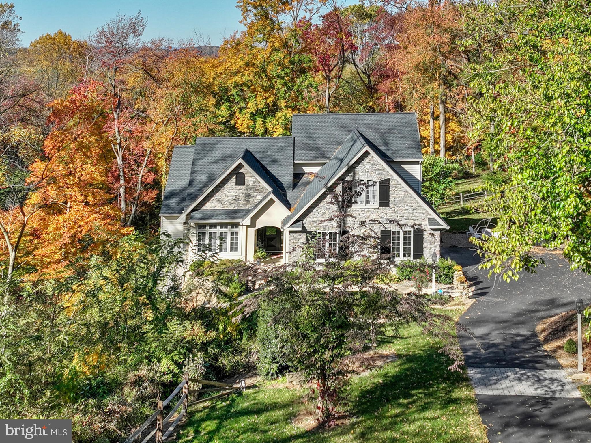 Escape to a beautiful estate nestled in 6 wooded acres in the heart of Lancaster County's farm land in the desirable Lampeter-Strasburg School District. The home features five bedrooms and 3 1/2 bathrooms. The first floor features a luxurious primary bedroom with a full bath with tile shower, as well as a deck and enclosed porch overlooking the wooded setting. The inviting living space includes a gas fireplace and room for entertaining or relaxation. Kitchen offers a convenient layout, stainless steel appliances, island, pantry and inviting eating area with lots of windows, first floor laundry room. Upstairs has 3 bedrooms and a bathroom provide ample spaces for family or guests. The finished daylight (walkout) basement features a large family room with an efficient propane fireplace, additional bedroom, bath, kitchen and lower level deck. The efficient propane HVAC system and propane water heater replaced in 2024. New Roof in 2021, new well pump and water treatment system in 2022.  Oversized 2-car garage. This home offers a total living area of 4,836 sq ft, a private retreat for you and your loved ones.   Easy access to major cities and airports. It’s approximately 1.5 hours from Philadelphia and Baltimore, 2.5 hours to  Washington, DC, and approximately 3 hours to New York City. Don't miss the opportunity to make this your dream home!
