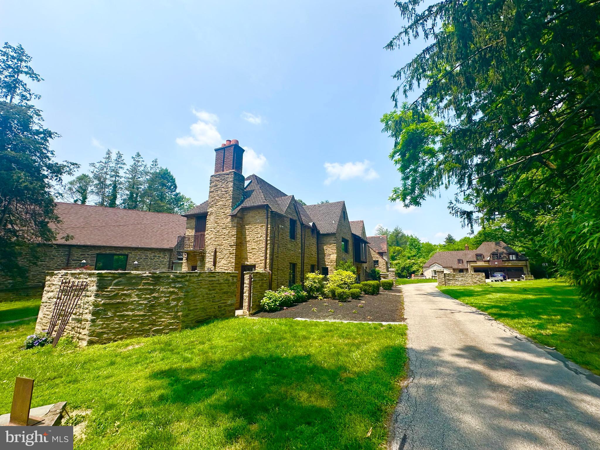 Set on 2.31 acres of private grounds, this 8,300+ sq ft stone estate offers a unique opportunity to own a 
compound-like property  Located in one of the Main Line’s most prestigious neighborhoods, this extra 
ordinary home features three self-contained living spaces, providing unparalleled flexibility. The main residence exudes warmth and elegance, with 8 bedrooms and 4 full baths, making it ideal for a growing household. Classic hardwood floors, multiple fireplaces, and exquisite custom woodwork create an 
inviting atmosphere throughout the home. The chef’s kitchen, with quartz countertops and a spacious prep area, serves as the heart of the home—perfect for both meals and entertaining. The formal dining room, adorned with rich wood paneling, provides an elegant setting for larger gatherings, while the cozy living room with its wood-burning fireplace is perfect for relaxation. The wood-paneled office offers a 
quiet retreat for work or study, and the renovated bathrooms, including two with luxurious steam showers, provide both comfort and convenience. A true highlight of this estate is the expansive gallery space—a versatile space with vaulted ceilings, exposed beams, and a striking stone fireplace. This self-contained area includes its own kitchen, modern bath, laundry, and private entrance, offering limitless possibilities. Whether used as a home theater, playroom, art studio, event venue, or even a dedicated guest suite, this exceptional space can easily be adapted to suit your needs. Above the detached garage, the carriage house apartment provides another private living space with its own kitchen, living room, bedroom, and bathroom—perfect for extended household, guests, or as a rental unit, The estate’s 2.31 acres create the perfect setting for outdoor enjoyment. Relax by the heated saltwater pool, host summer gatherings on the stone terrace, or unwind in the glass-enclosed sunroom overlooking the serene backyard. With dual private entrances from Remington and Morris Roads, the property offers complete privacy, while still providing easy access to surrounding amenities. Ample parking ensures your guests are always accommodated, making this estate ideal for reunions, holidays, or any large gathering. This estate is an extraordinary place to call home.