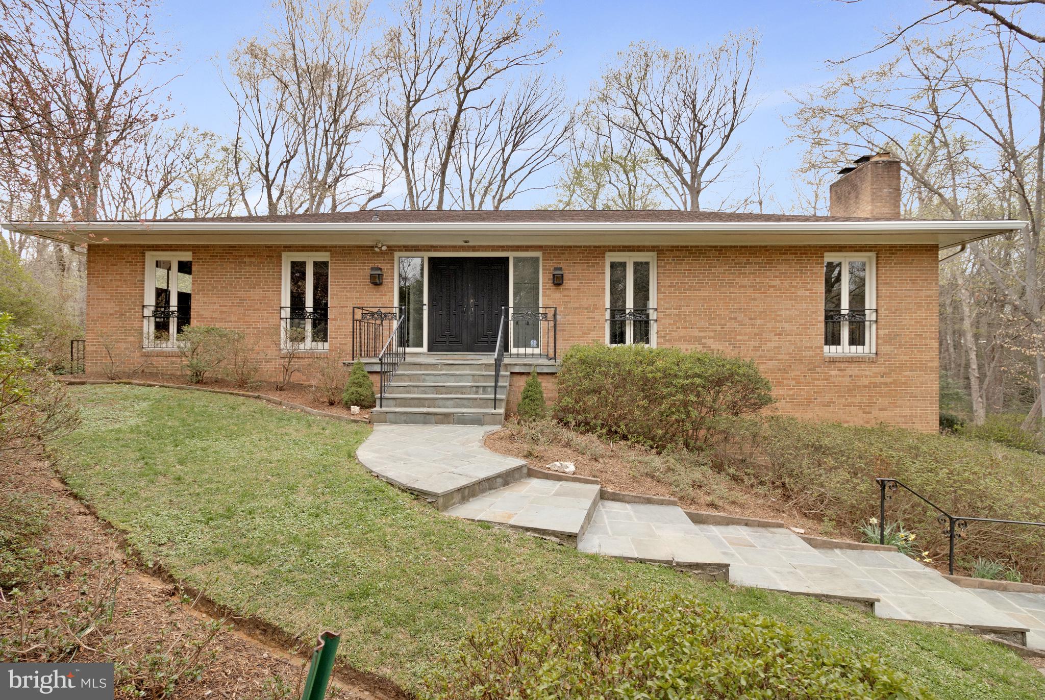 This exceptional 5-bedroom, 3-bathroom contemporary home in the coveted Chain Bridge Forest neighborhood offers a seamless blend of modern design, ultimate privacy, and unparalleled convenience—with only one stoplight to D.C.. Nestled on a quiet street and backing up to lush parkland, this home provides a peaceful retreat while remaining close to city life.
Main Level: Designed for Comfort & Entertaining
With 10-foot ceilings throughout, the main level is bright, open, and thoughtfully designed. The circular flow of the living, dining, and kitchen areas makes entertaining effortless. Expansive windows and glass doors bring in natural light and provide stunning views of the private backyard and parkland beyond.
A standout feature of this level is the dedicated office/study with a wet bar and spacious closet, offering flexibility to function as a 6th bedroom if needed. The kitchen is of grand proportion  with plenty of cabinetry, and space for an eat-in table—perfect for casual gatherings or meal prep. Just off the living area, a large rear deck extends the living space outdoors, making it the perfect spot for morning coffee or al fresco dining while immersed in nature.
Lower Level: Spacious & Functional
The lower level is equally impressive, with high ceilings and a bright, open recreation room that walks out to the side of the house. This level offers three generously sized bedrooms and a large full bathroom, creating an ideal setup for guests, family members, or even an in-law suite. Additional Features include Side-loading 2-car garage for enhanced curb appeal; Ultimate privacy with parkland as your backyard; Quiet, tree-lined street in a highly desirable neighborhood; Easy access to D.C. with just one stoplight. This stunning contemporary home offers the best of both worlds—modern elegance and natural tranquility—making it a rare gem in Chain Bridge Forest.