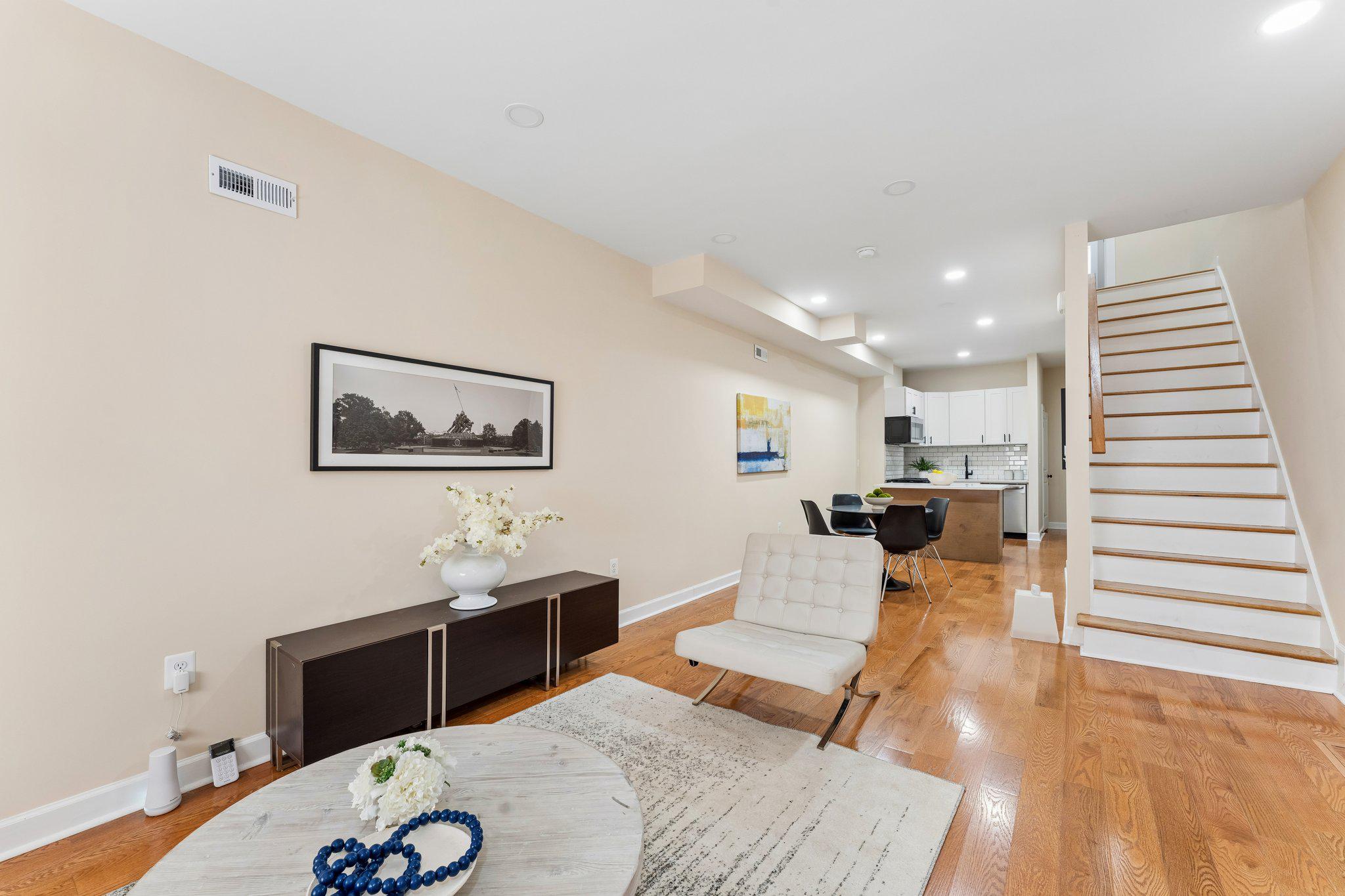 Hard-to-find 3-bedroom, 3 full bath, 1 half bath layout with a pristine full renovation, finished lower level, and rear exterior access in Baltimore’s East Monument Historic District. This East Baltimore rowhome features 2 upper-level bedrooms with 2 full baths, a main-level powder room, and a finished lower level with a bedroom, full bath, and flexible space for guests, extended living, a home office, or possible rental income use, subject to buyer verification. The open main level offers hardwood floors, recessed lighting, a bright living area, dining space, and a modern kitchen with granite counters, subway tile backsplash, stainless steel appliances, and gas cooking. Upper-level laundry adds everyday convenience. Enjoy a fenced concrete rear patio ready for outdoor seating, container gardening, or entertaining. Minutes from Johns Hopkins Hospital, Henderson-Hopkins School, Patterson Park, Northeast Market, Yard 56, local dining, shops, transit, and major commuter routes, this move-in-ready home offers modern comfort and a walkable Johns Hopkins/East Baltimore location.
